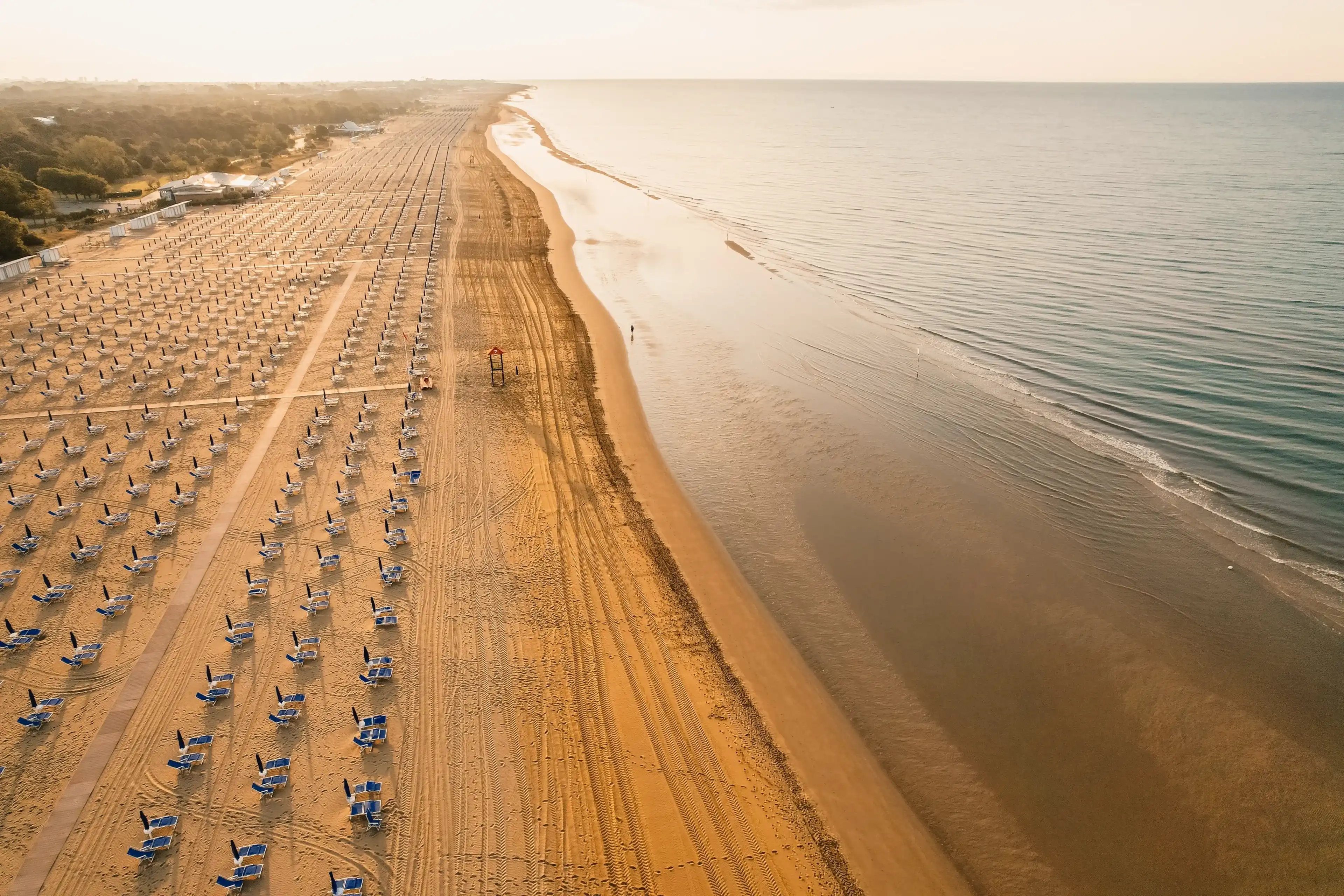 Morning on the still deserted beach. Umbrella beach for relaxing and sun set beach. Bibione, Italy Morning on the still deserted beach. Umbrella beach for relaxing and sun set beach. Bibione, Italy