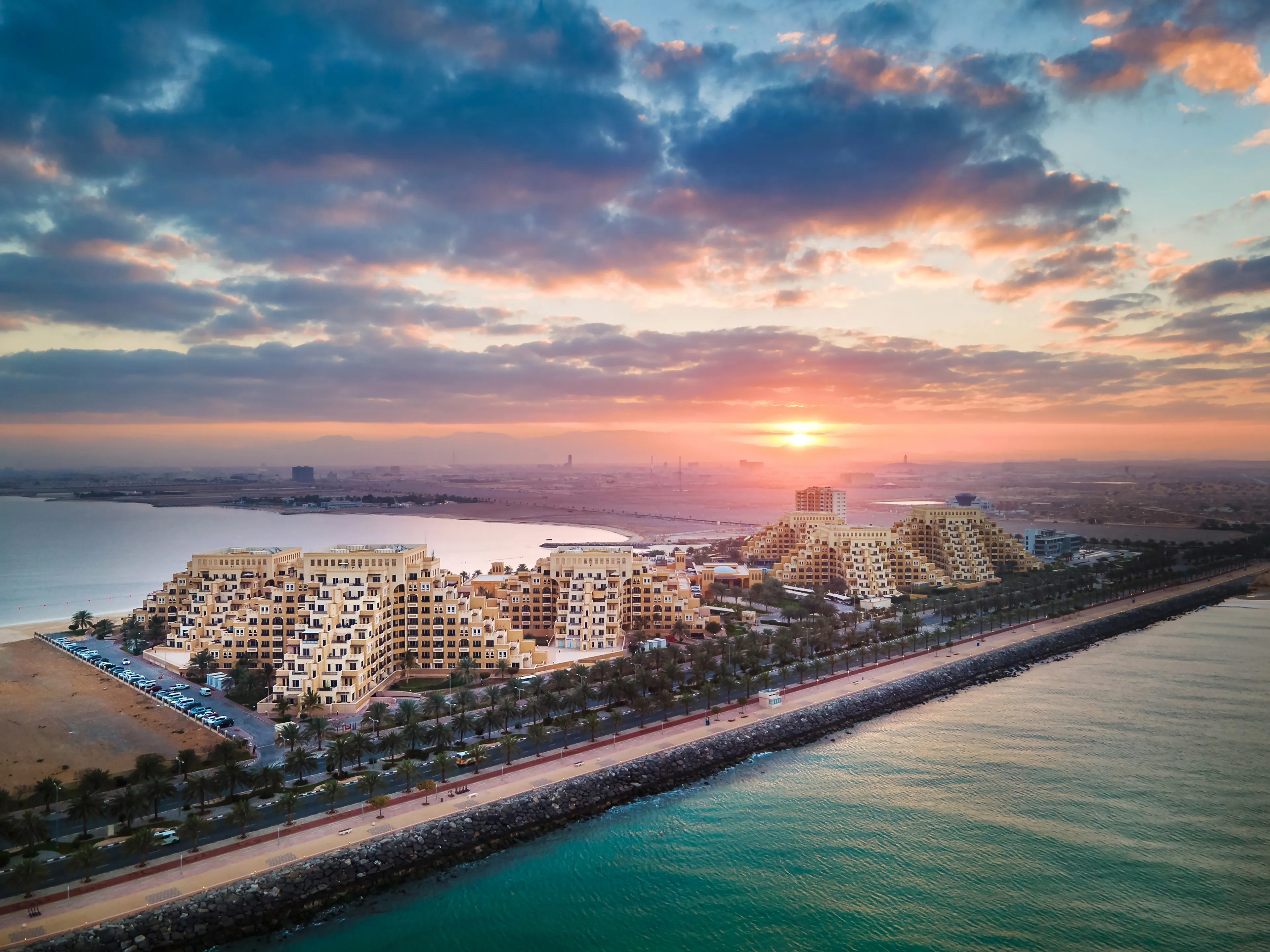 Sunrise over Marjan Island seafront reclaimed land artificial island in emirate of Ras al Khaimah in the United Arab Emirates aerial view