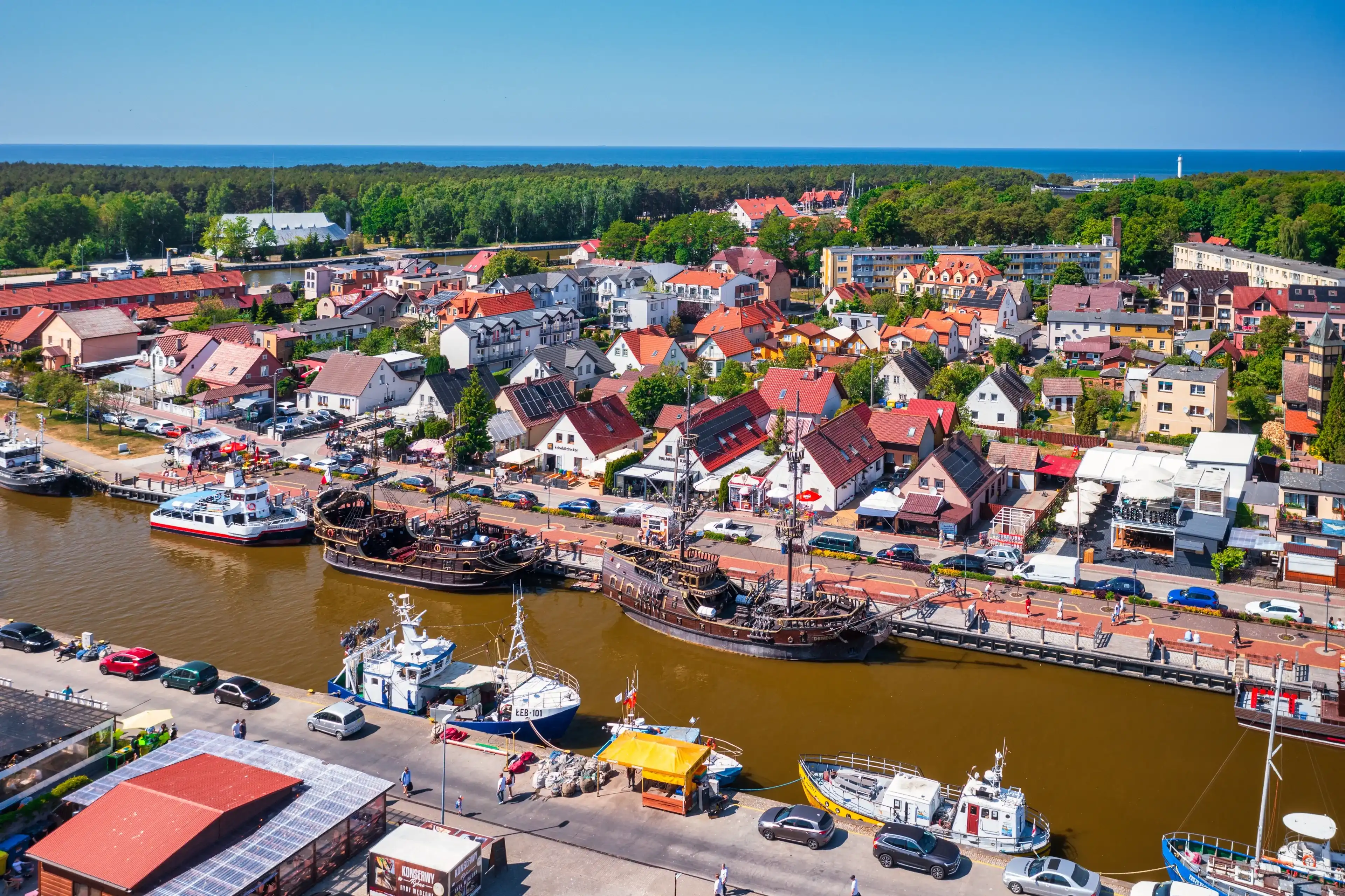 Leba, Poland - June 8, 2023: Ships in the port of Leba town by the Baltic Sea, Poland. Leba is a popular tourist destination by the Baltic Sea in Poland. Leba, Poland - June 8, 2023: Ships in the port of Leba town by the Baltic Sea, Poland. Leba is a popular tourist destination by the Baltic Sea in Poland.