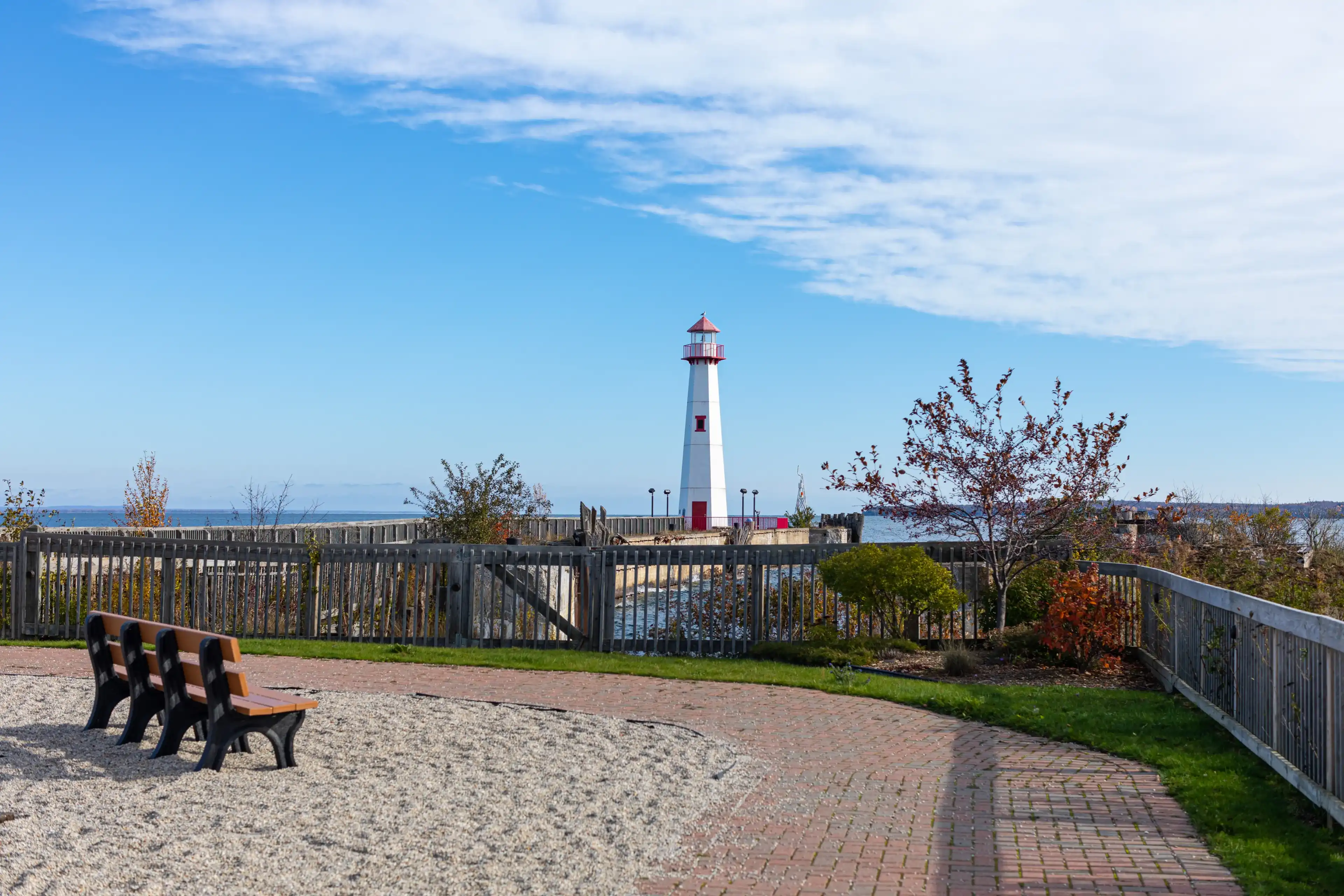 Wawatam Lighthouse in St. Ignace, Michigan, United States of America, Mackinac Island on the background Wawatam Lighthouse in St. Ignace, Michigan, United States of America, Mackinac Island on the background