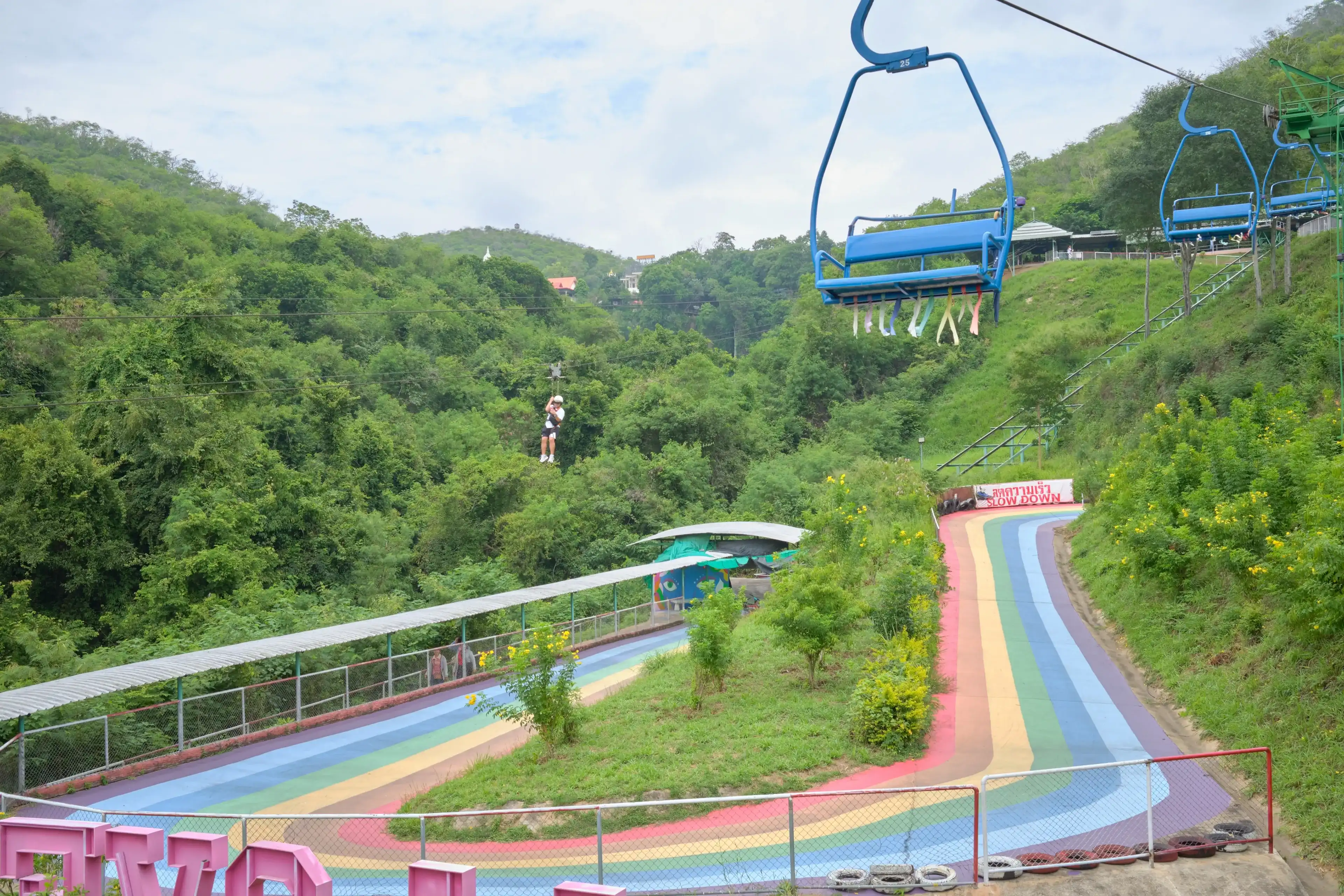 Nakhon Ratchasima, Thailand - Sep 14, 2024 : Tourist are enjoy hanging the Flying Fox down from the hill at Thongsomboon Club near Pak Chong, Khao Yai National Park. Nakhon Ratchasima, Thailand - Sep 14, 2024 : Tourist are enjoy hanging the Flying Fox down from the hill at Thongsomboon Club near Pak Chong, Khao Yai National Park.