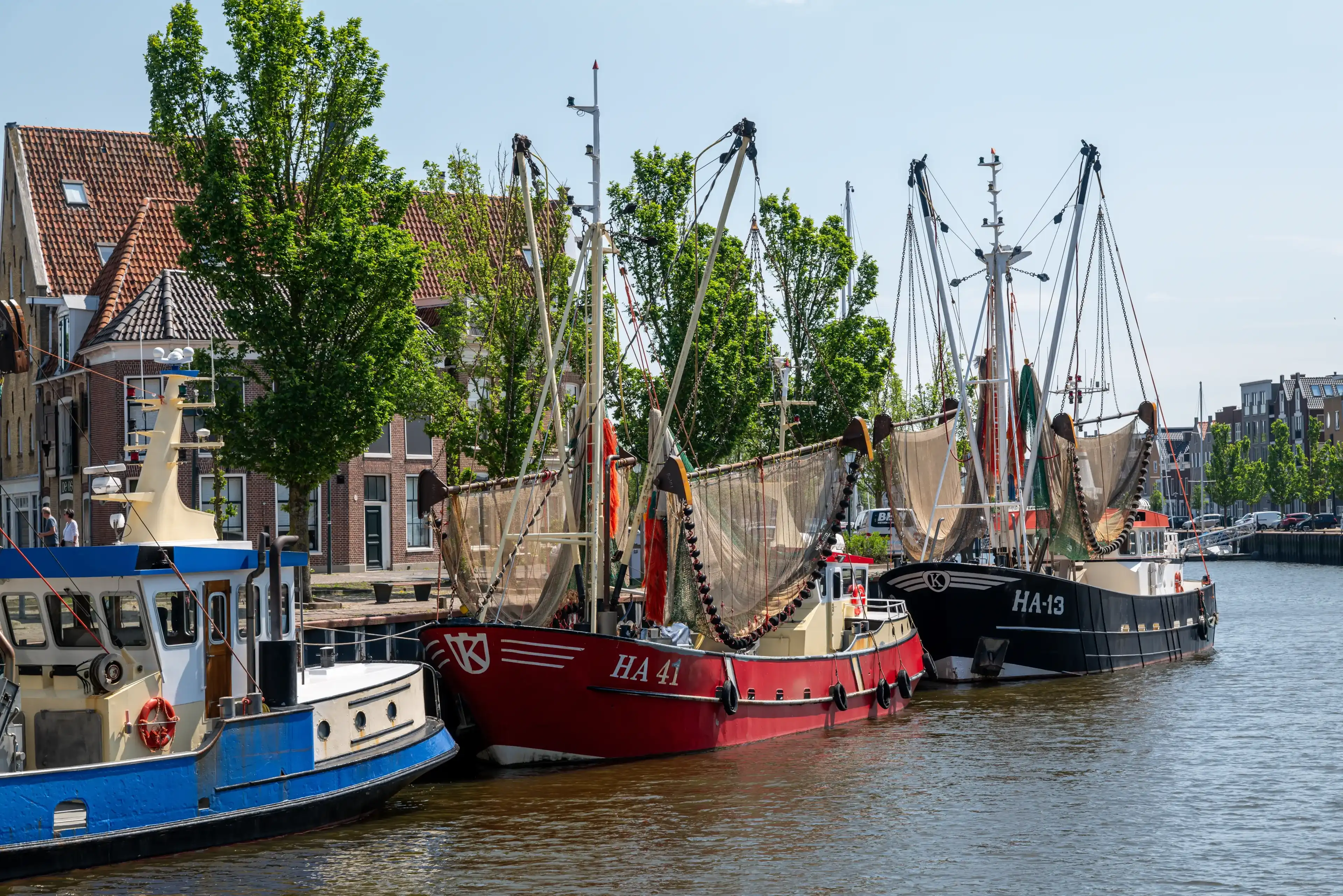Harlingen, The Netherlands - 2024-05-20: Fishing vessels in the old harbour, with the fishing net drying in the sun Harlingen, The Netherlands - 2024-05-20: Fishing vessels in the old harbour, with the fishing net drying in the sun
