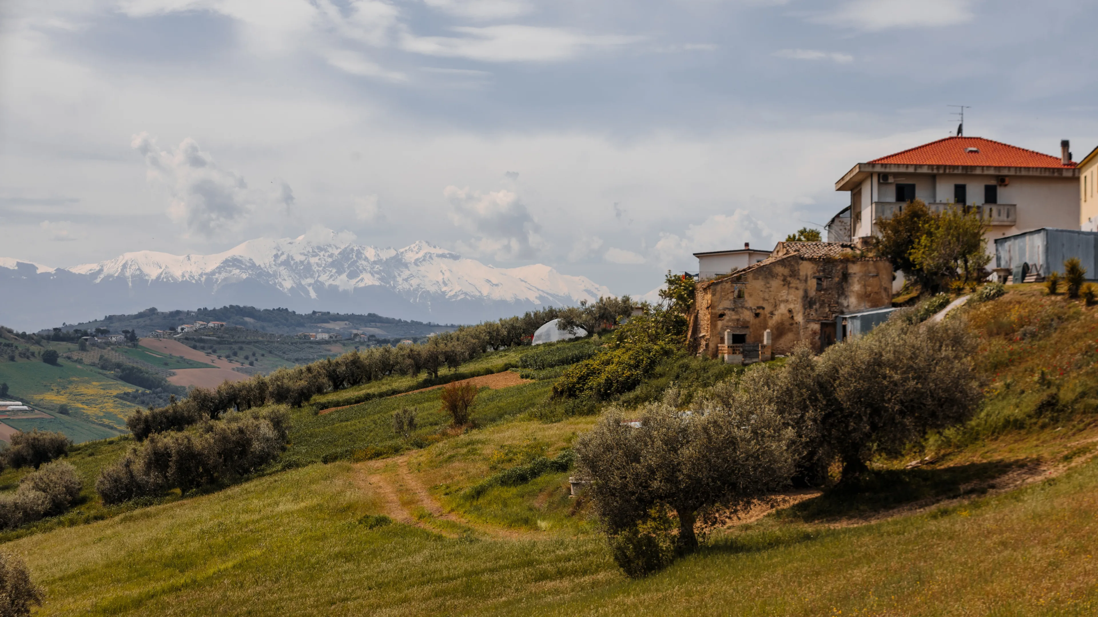View from a hill in the city of Pineto, Italy, to the Apennine Mountains. picturesque Italian hills and snowy mountains on the horizon.