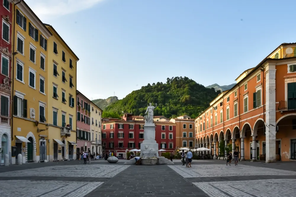 Carrara Italy 04.06.2022: Captivating Carrara: A Glimpse of the Beautiful Central Square with Vibrantly Colored Buildings