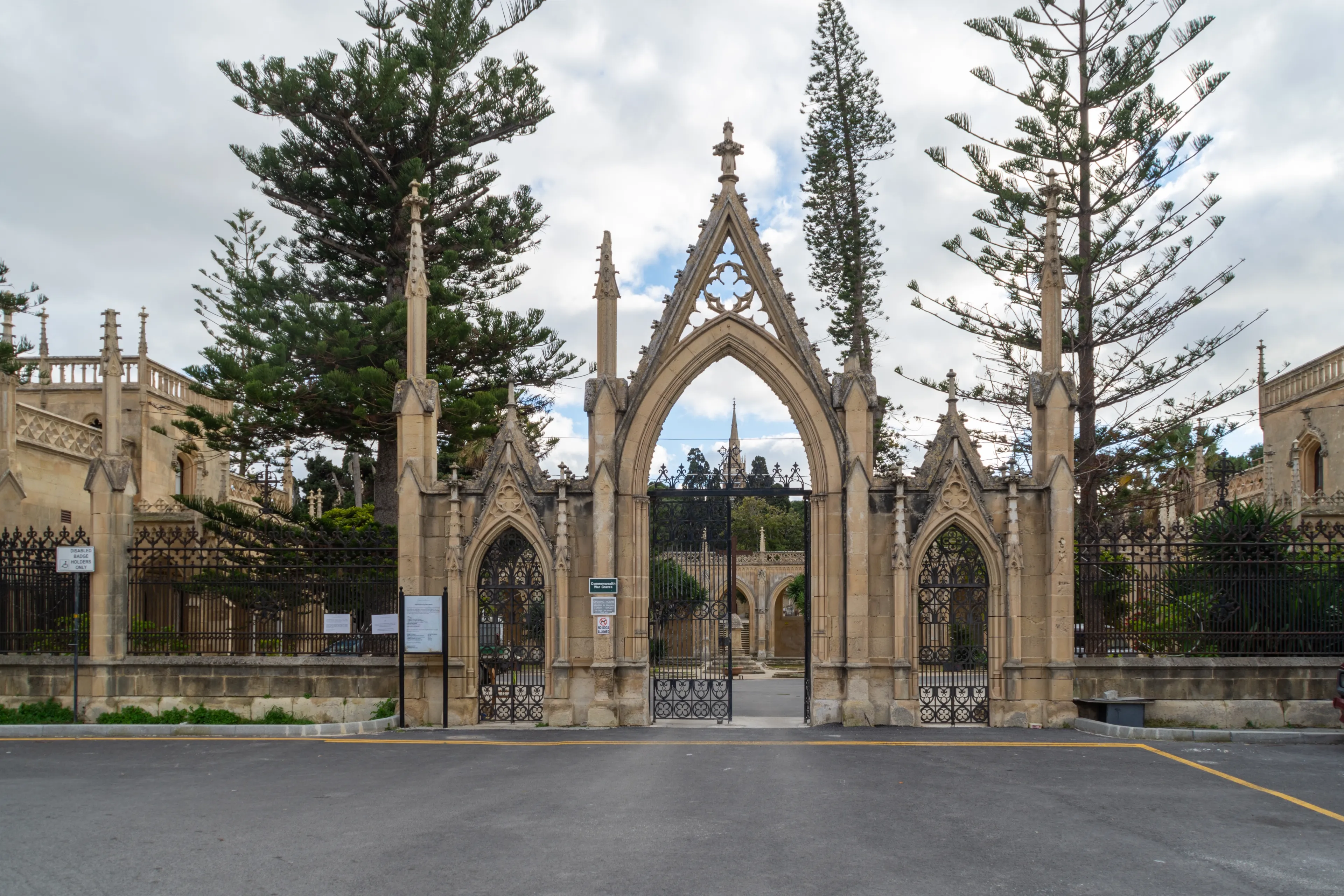 Paola, Malta - January 28th 2022: The entrance with a gatehouse on either side at the Santa Maria Addolorata Cemetery also known as the Addolorata Cemetery. 