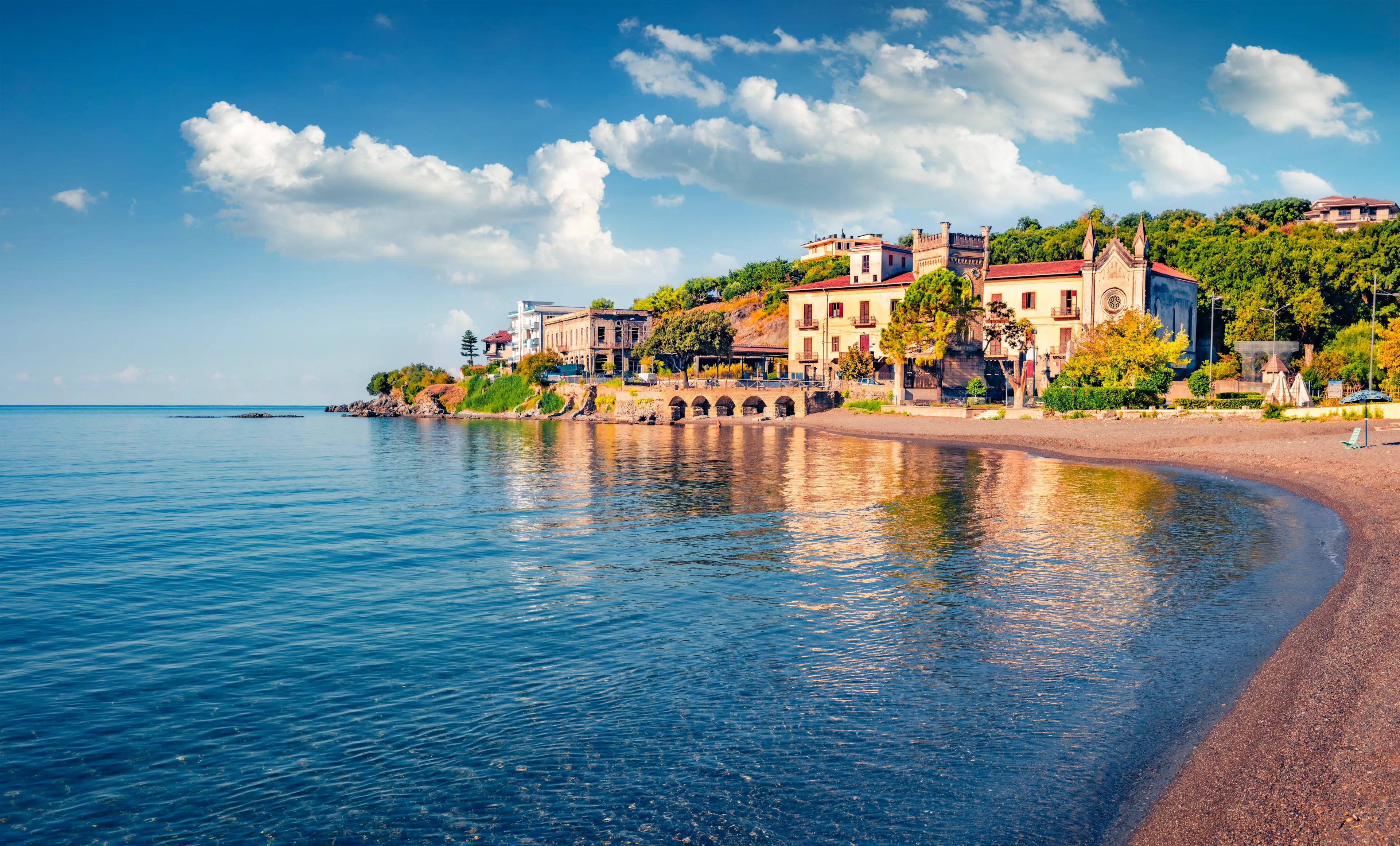 Stunning morning view of historical landmark - Torre della Specola and Santa Croce church. Bright summer cityscape of Sapri town, Italy. Beautiful Mediterranean seascape. Vacation concept background.