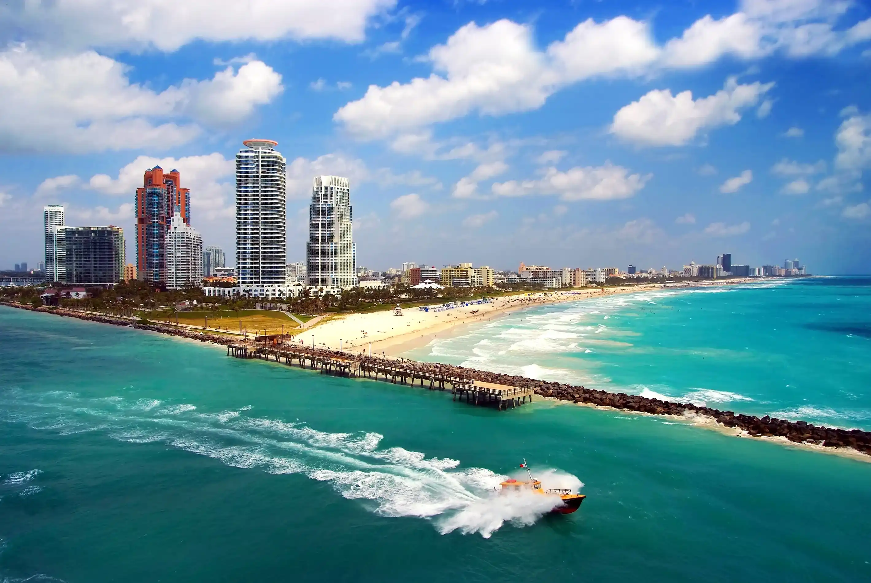 Aerial view of South Miami Beach with Pilot boat sailing next to the city line Aerial view of South Miami Beach with Pilot boat sailing next to the city line