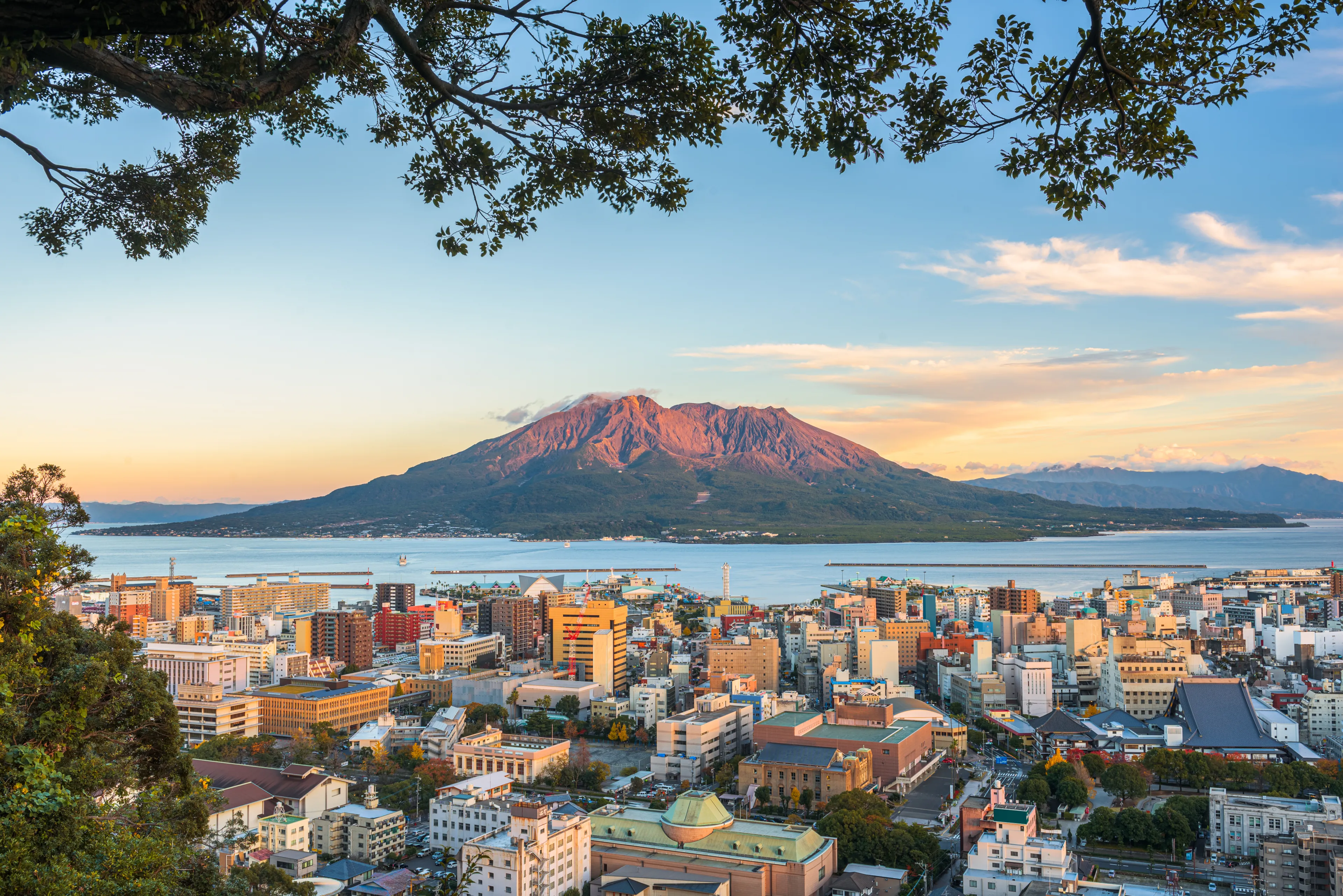 Kagoshima, Japan skyline with Sakurajima Volcano at dusk.