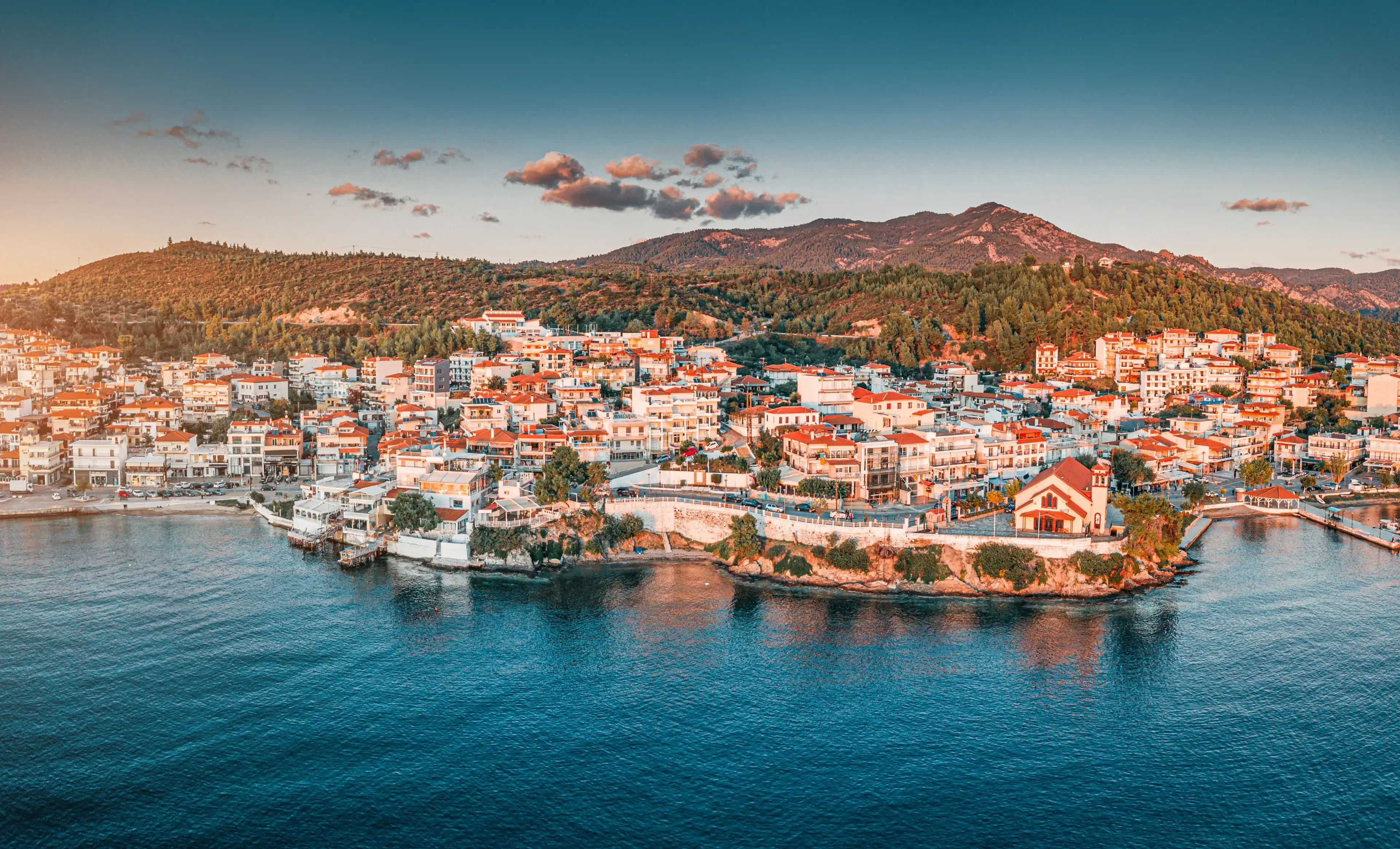Orthodox Church of Taxiarch Angels among Houses and villas in a resort town Neos Marmaras in Sithonia, Halkidiki, Greece Orthodox Church of Taxiarch Angels among Houses and villas in a resort town Neos Marmaras in Sithonia, Halkidiki, Greece