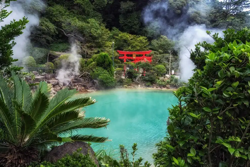 umi jigoku or sea hell taken in beppu with steamy hot springs geyser steaming off the cobalt water. Red torii gates nearby the geyser. Taken in Beppu, Japan umi jigoku or sea hell taken in beppu with steamy hot springs geyser steaming off the cobalt water. Red torii gates nearby the geyser. Taken in Beppu, Japan