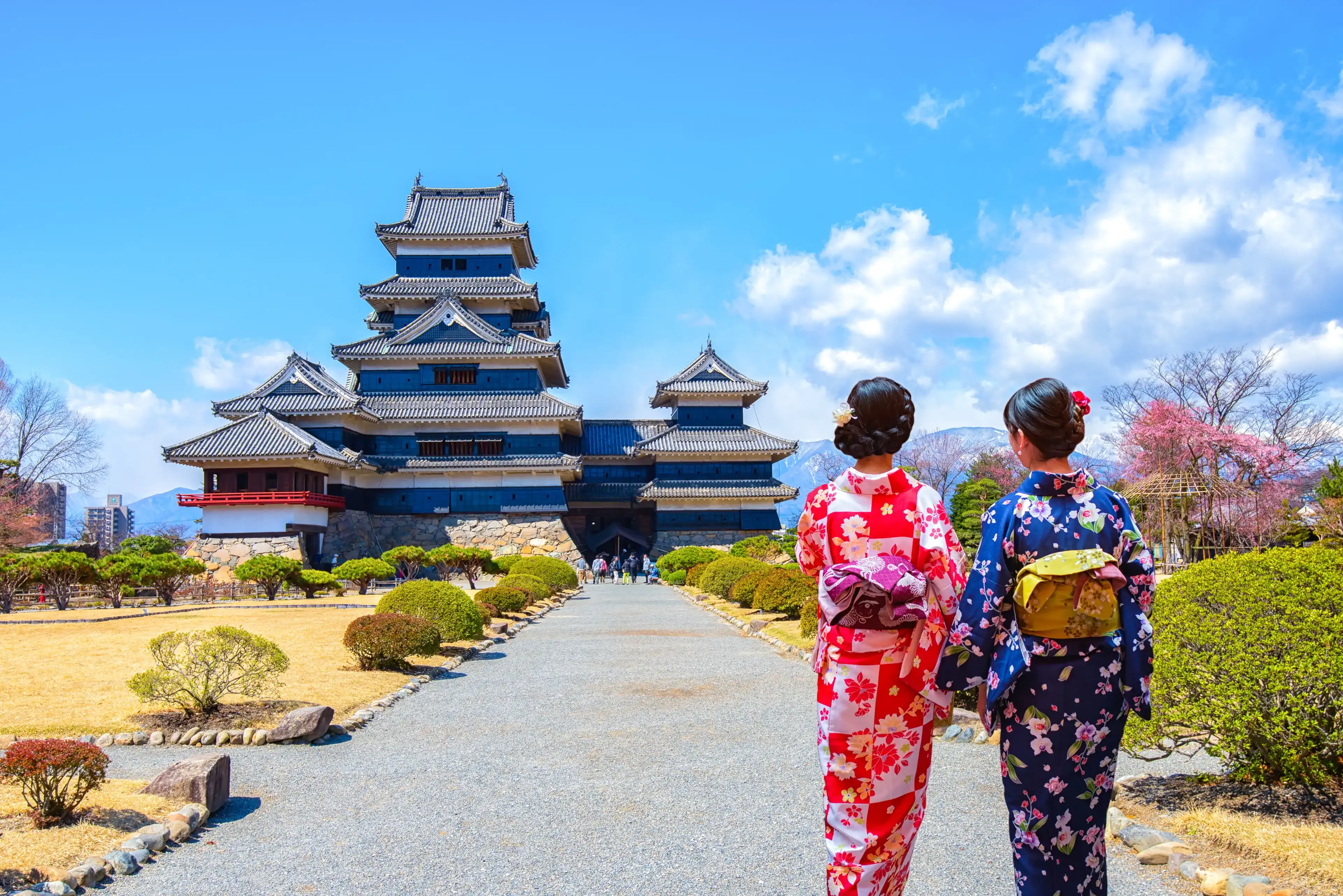 Two geishas wearing traditional japanese kimono among Matsumoto Castle is one of the most complete and beautiful among Japan's original castles. Two geishas wearing traditional japanese kimono among Matsumoto Castle is one of the most complete and beautiful among Japan's original castles.