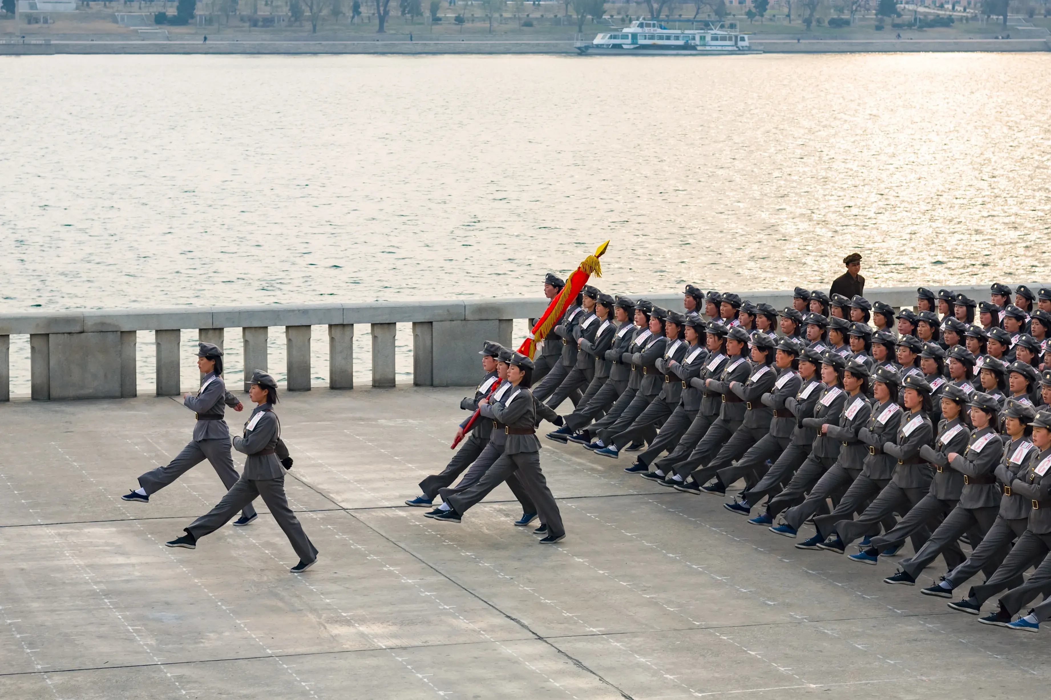 PYONGYANG, NORTH KOREA, MARCH 26, 2008: Juche tower esplanade, squad of female teenagers in military uniforms rehearses for a parade PYONGYANG, NORTH KOREA, MARCH 26, 2008: Juche tower esplanade, squad of female teenagers in military uniforms rehearses for a parade