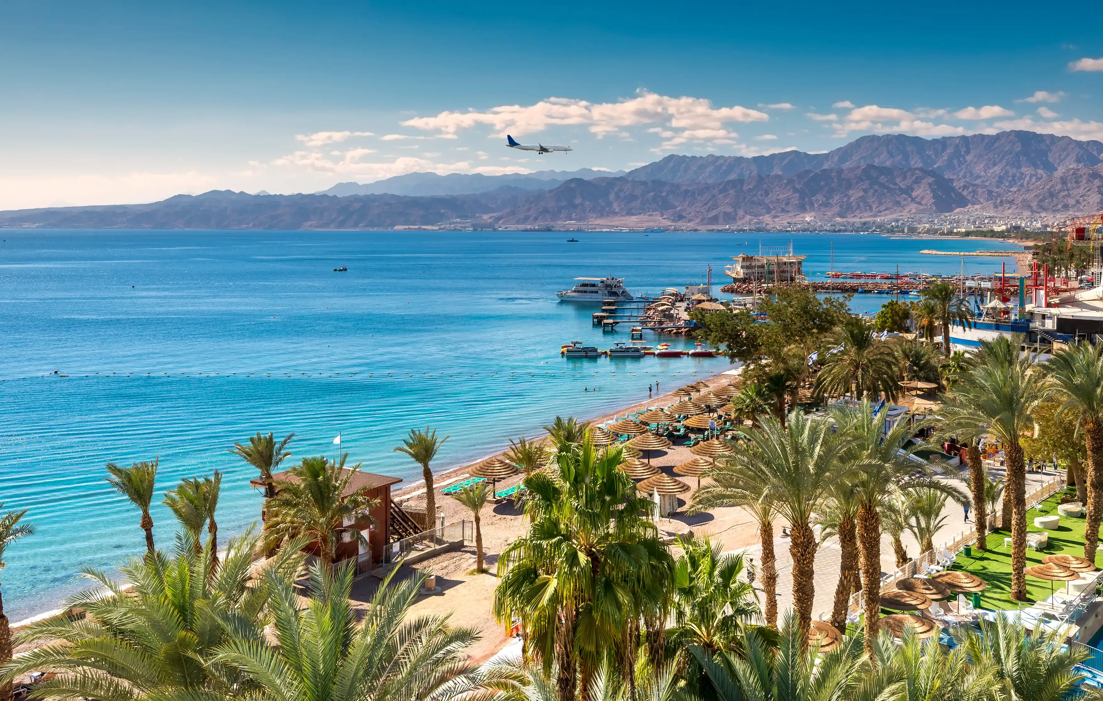 Central beach and marina in Eilat - famous resort and recreation city in Israel. This serene location is a very popular tropical getaway for Israeli and European tourists. Central beach and marina in Eilat - famous resort and recreation city in Israel. This serene location is a very popular tropical getaway for Israeli and European tourists.