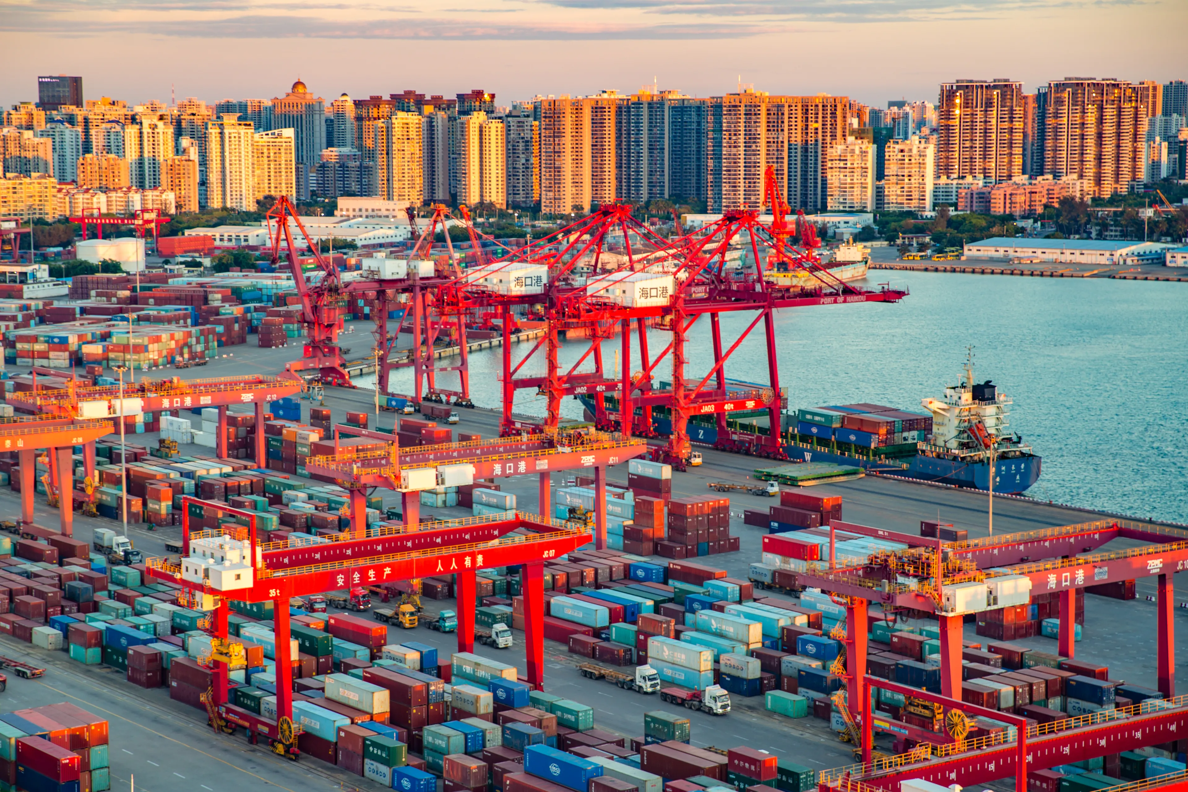 Haikou, Hainan, China - June 17th 2020: Haikou Port Container Terminal Aerial View During Sunset, The Main Transportation Hub for Hainan Pilot Free Trade Zone and Free Trade Port of China.