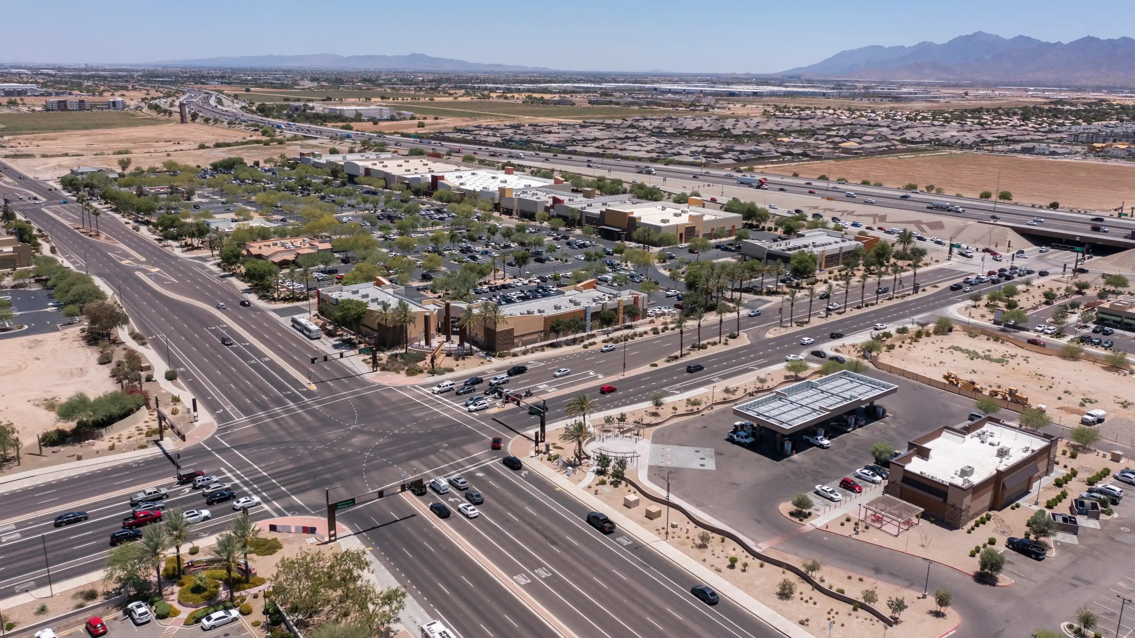 Afternoon aerial view of new shopping mall sprawl and empty lots of downtown Goodyear, Arizona, USA. Afternoon aerial view of new shopping mall sprawl and empty lots of downtown Goodyear, Arizona, USA.