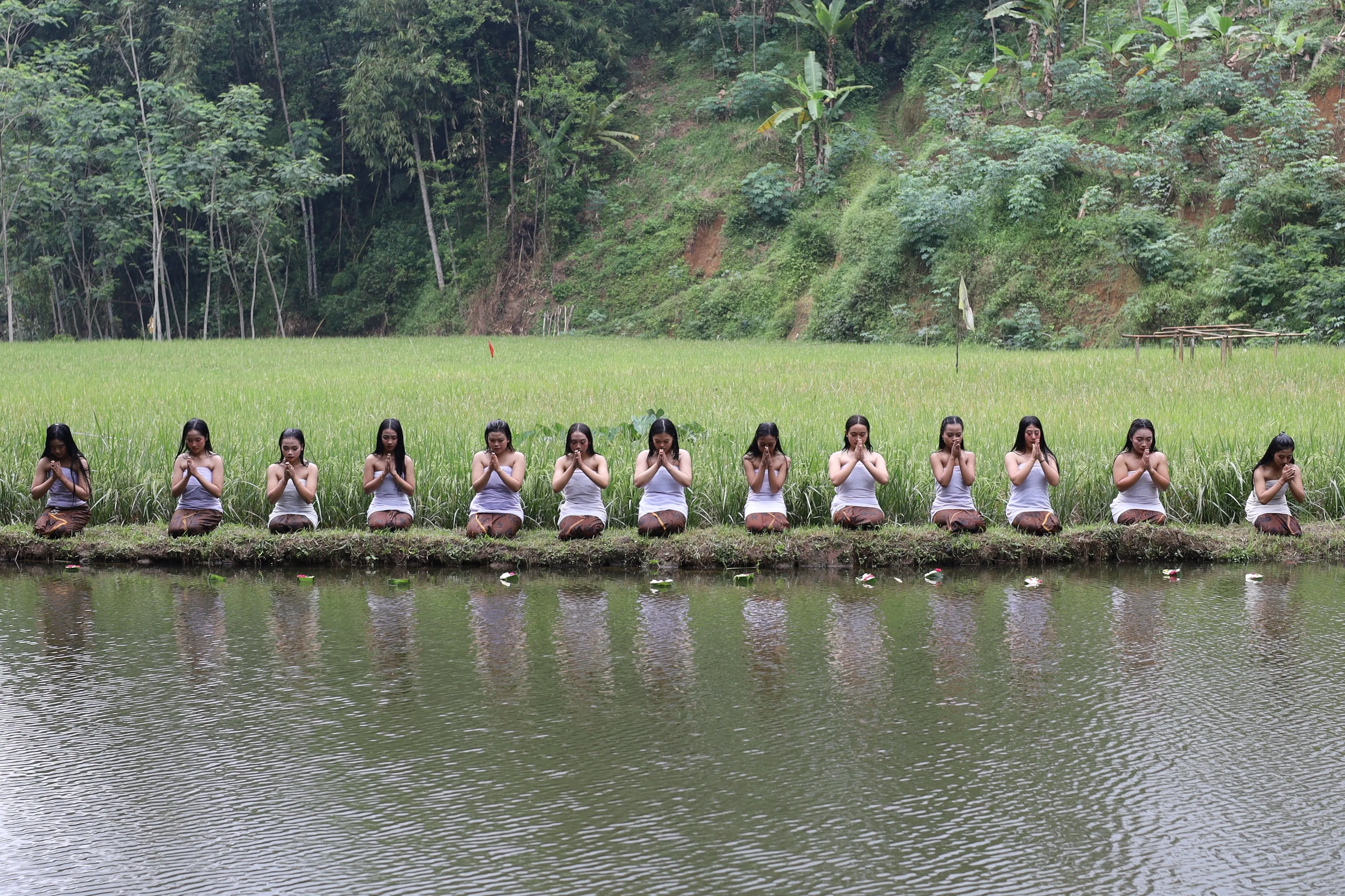 Wonosobo, Indonesia - July 8, 2023: Lengger candidates throw offerings into a sacred pool as the closing ceremony for the lengger graduation ceremony in Giyanti Village, Wonosobo, Indonesia.