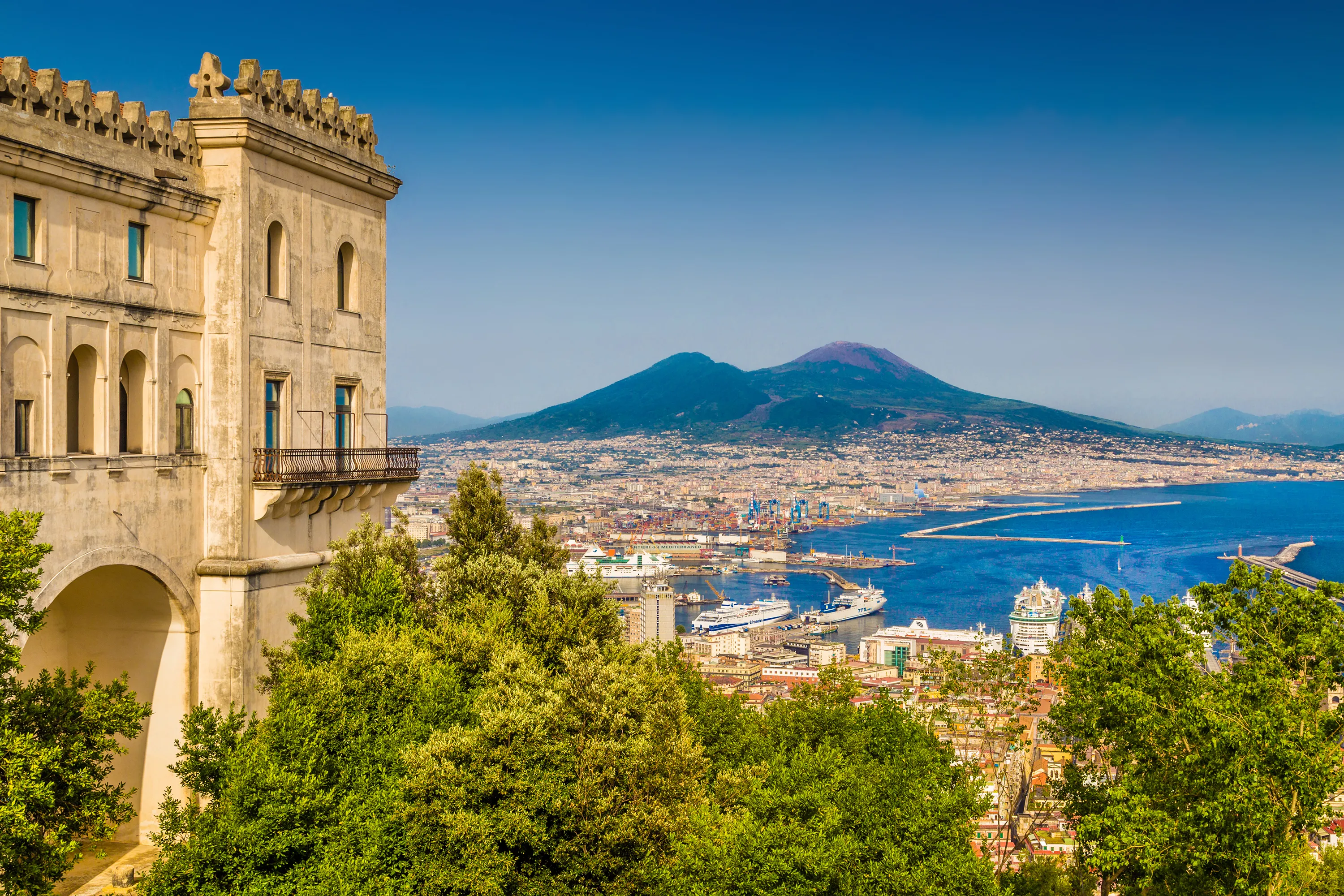 Scenic picture-postcard view of the city of Naples (Napoli) with famous Mount Vesuvius in the background from Certosa di San Martino monastery, Campania, Italy