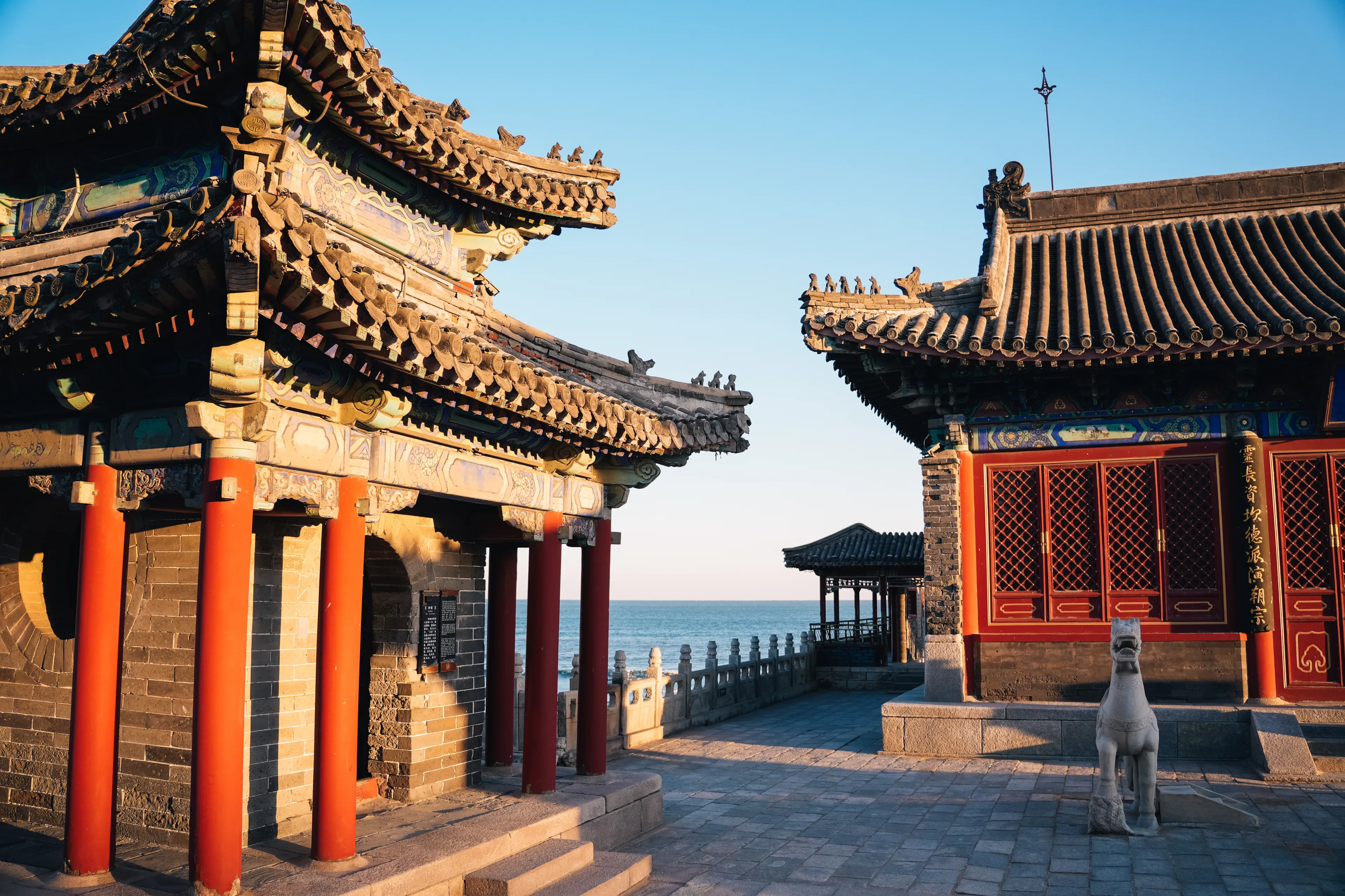 Buddhist temple on the beach with the sea in the background on a sunny day at sunset, Qinhuangdao, China