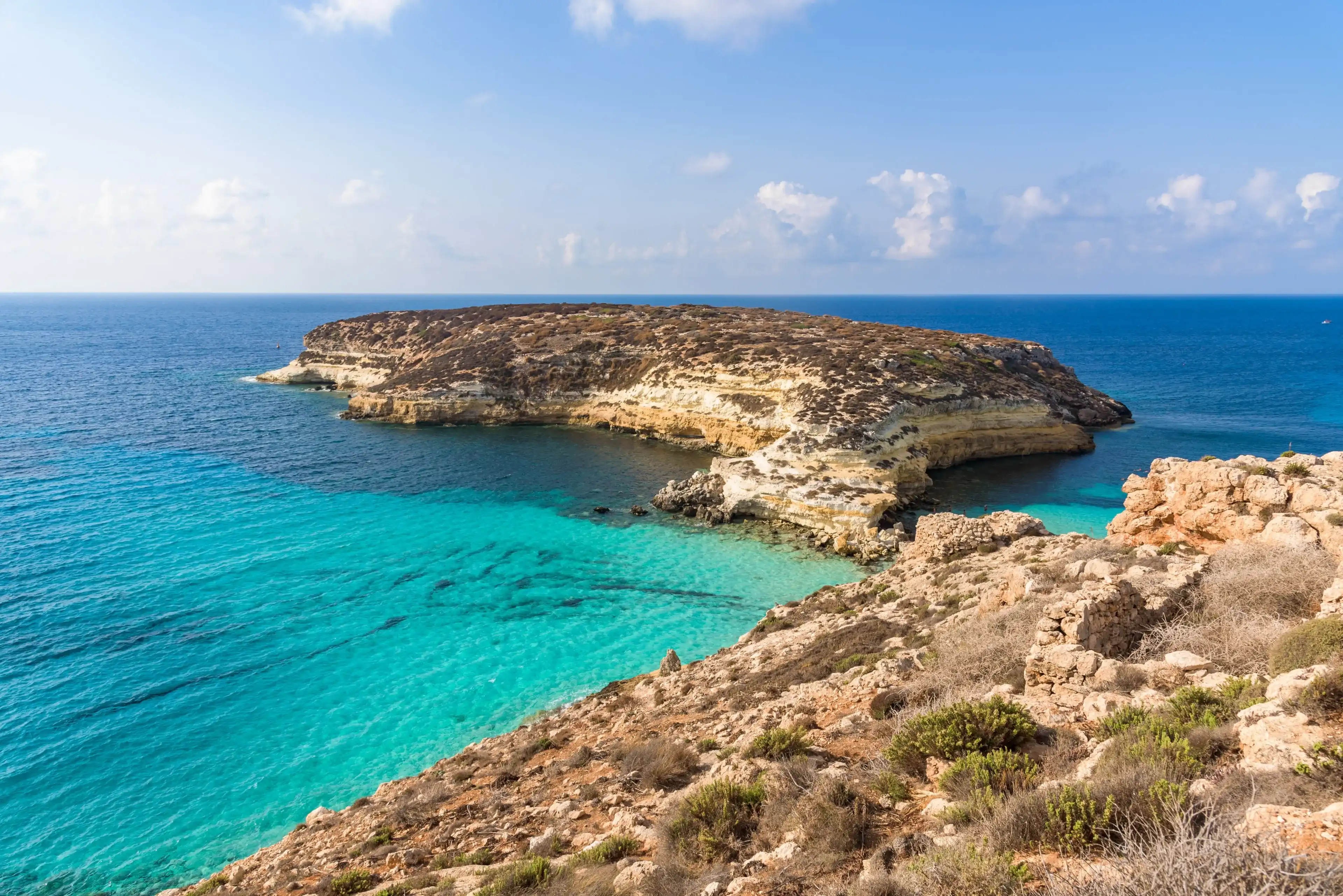 Isola dei Conigli (Rabbit Island) and its beautiful beach with turquoise sea water. Lampedusa, Sicily, Italy. Isola dei Conigli (Rabbit Island) and its beautiful beach with turquoise sea water. Lampedusa, Sicily, Italy.
