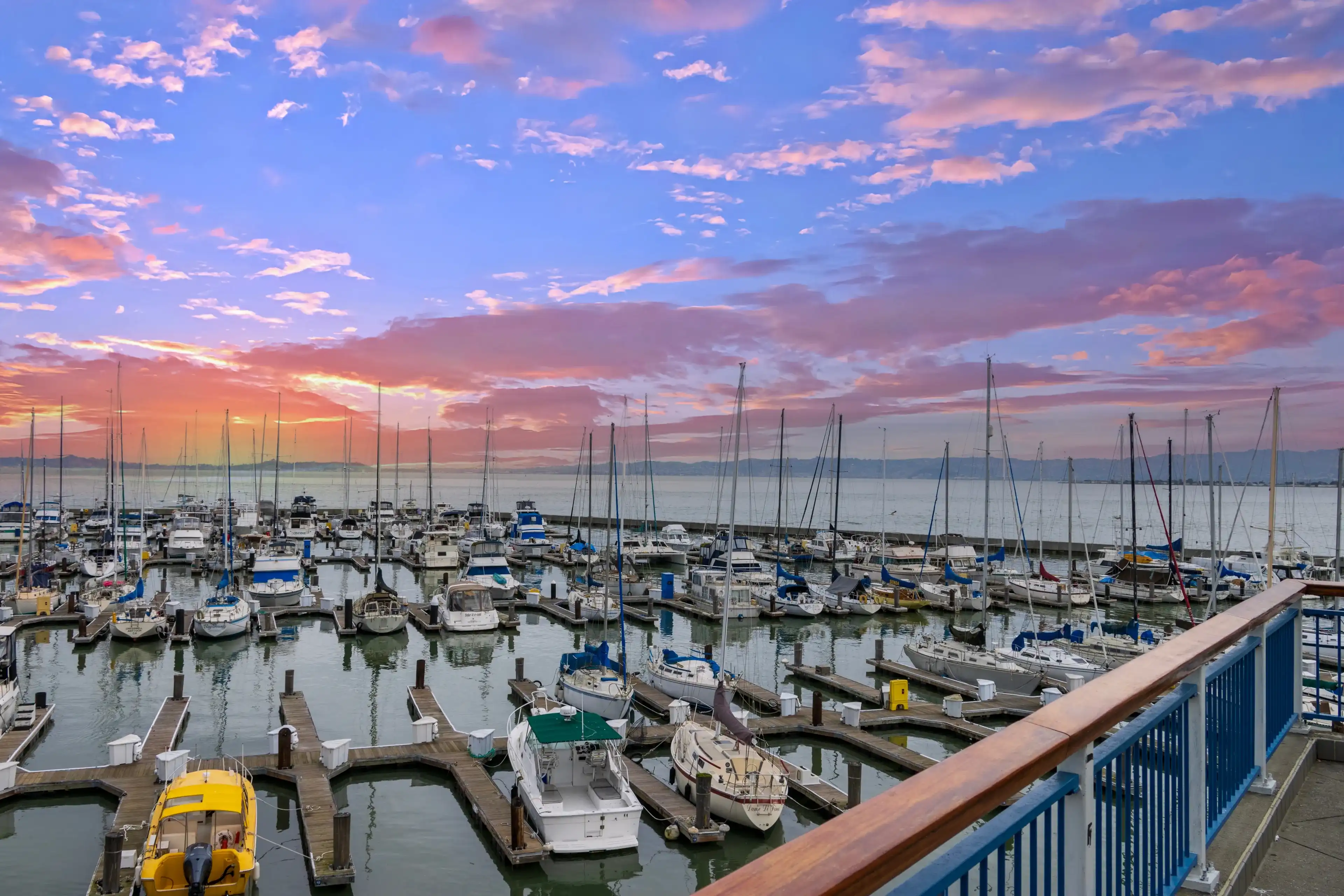 San Francisco California USA - 1 24 2024: a beautiful spring landscape at Fisherman's Wharf on Pier 39 with boats and yachts docked in the harbor with ocean water at sunset in San Francisco California San Francisco California USA - 1 24 2024: a beautiful spring landscape at Fisherman's Wharf on Pier 39 with boats and yachts docked in the harbor with ocean water at sunset in San Francisco California