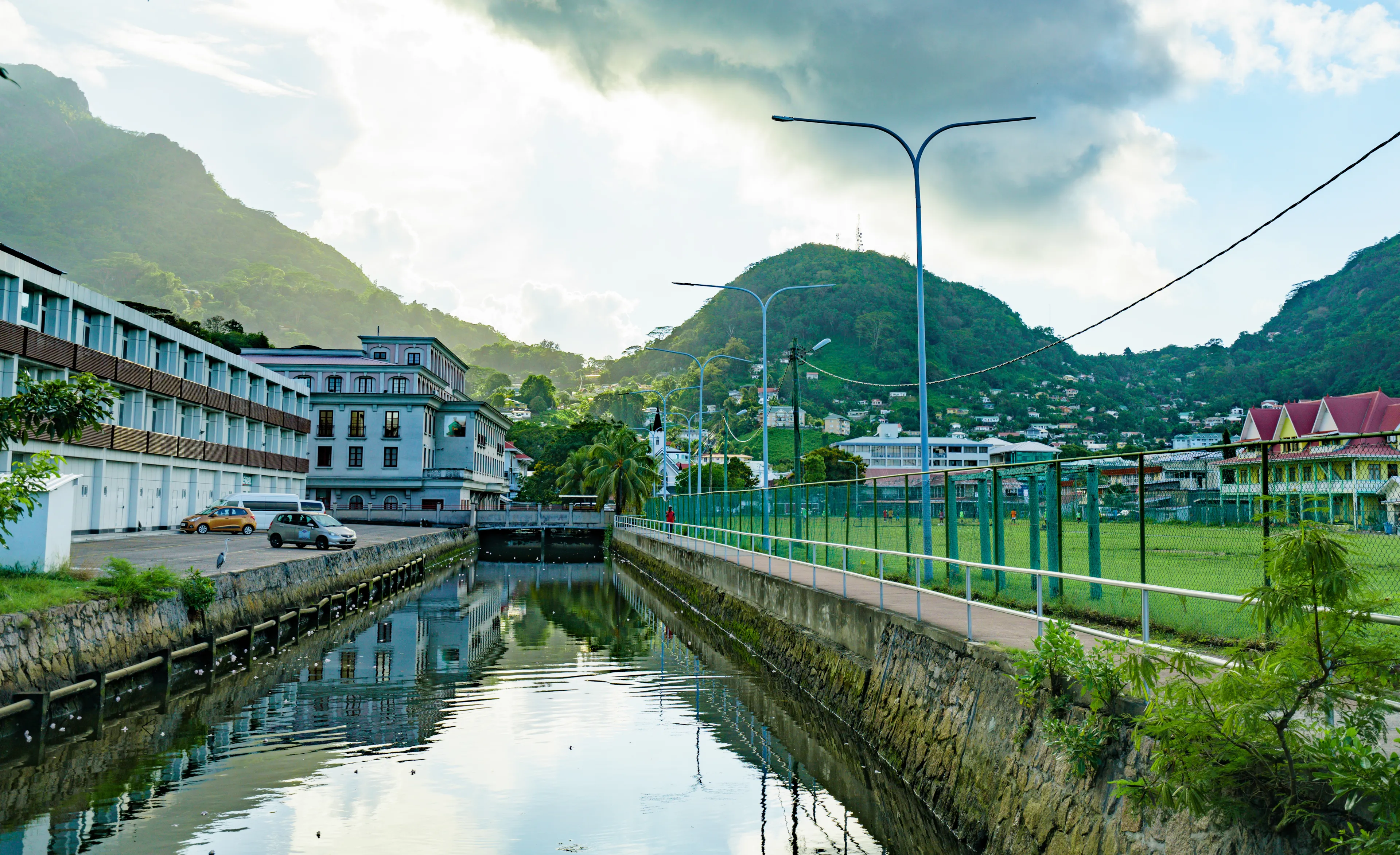 VICTORIA, SEYCHELLES - October 06, 2019: Part of the English River and a football stadium (Freedom Square) with a mountain and forest view.