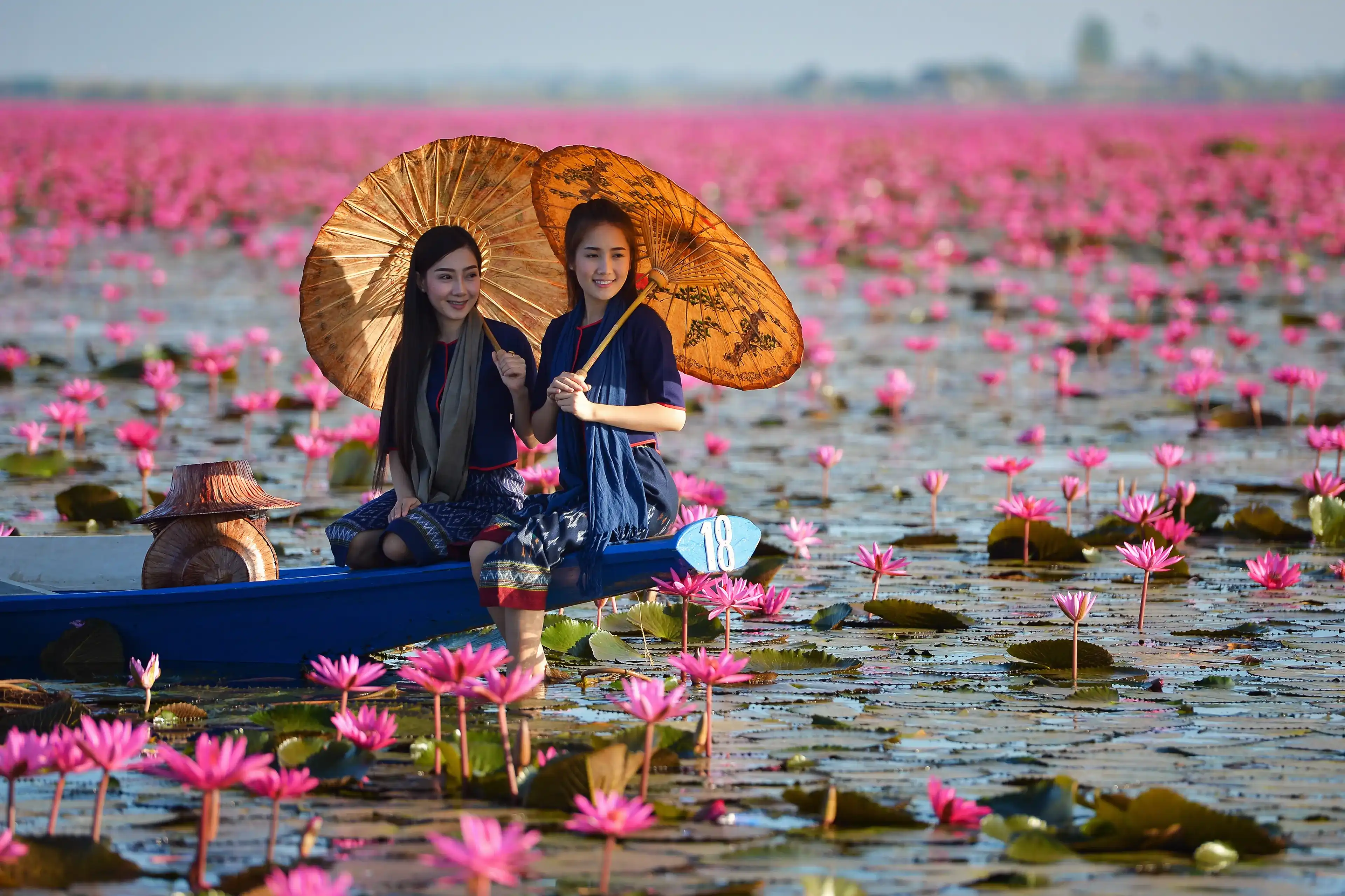 Laos woman in flower lotus lake, Woman wearing traditional Thai people , Red Lotus Sea UdonThani Thailand Laos woman in flower lotus lake, Woman wearing traditional Thai people , Red Lotus Sea UdonThani Thailand