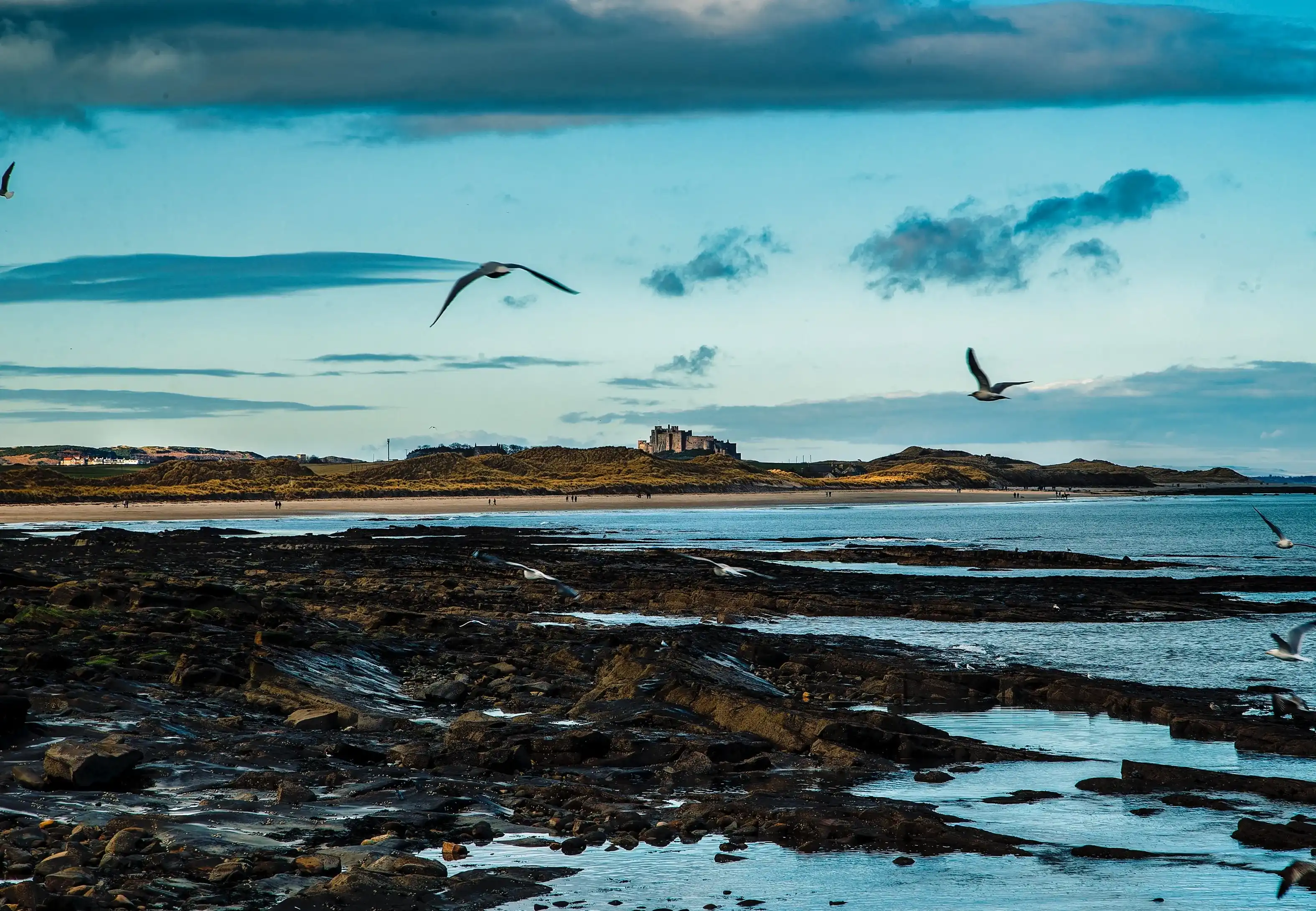 Seahouse, United Kingdom-January 20, 2018: Bamburgh Castle from the harbour at Aeahouses, in Northumberland, England. Seahouse, United Kingdom-January 20, 2018: Bamburgh Castle from the harbour at Aeahouses, in Northumberland, England.