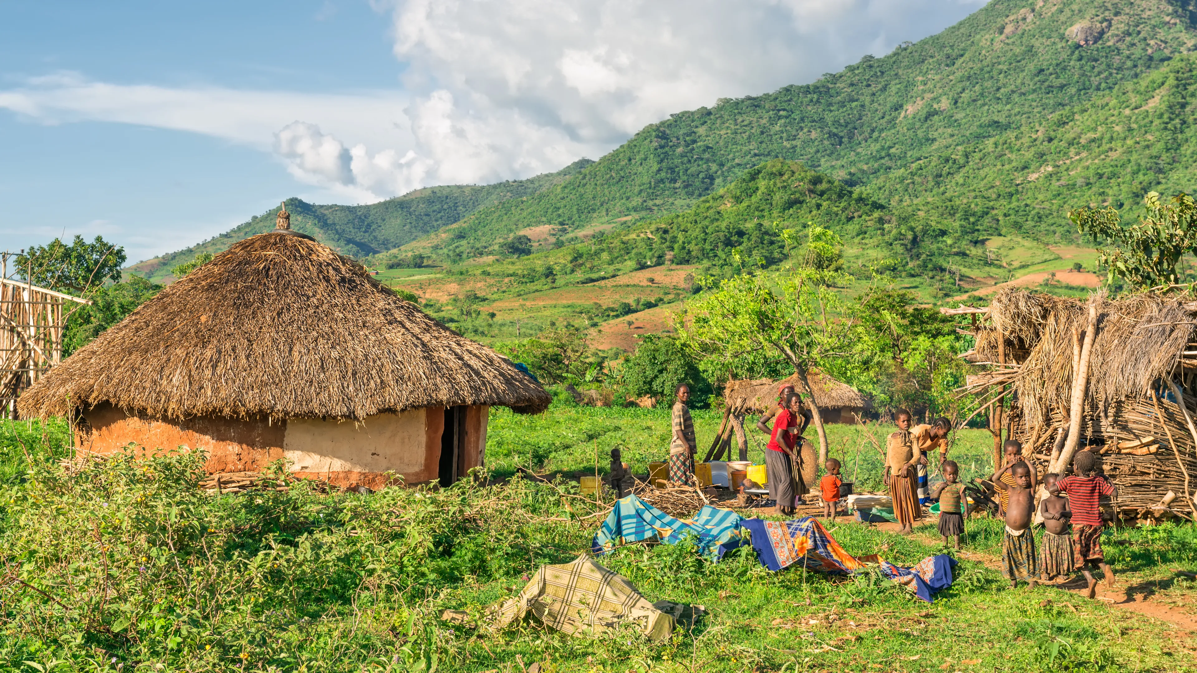 OMO VALLEY, ETHIOPIA - MAY 6, 2015 : Ethiopian family preparing dinner in front of their home in the southern part of Ethiopia.