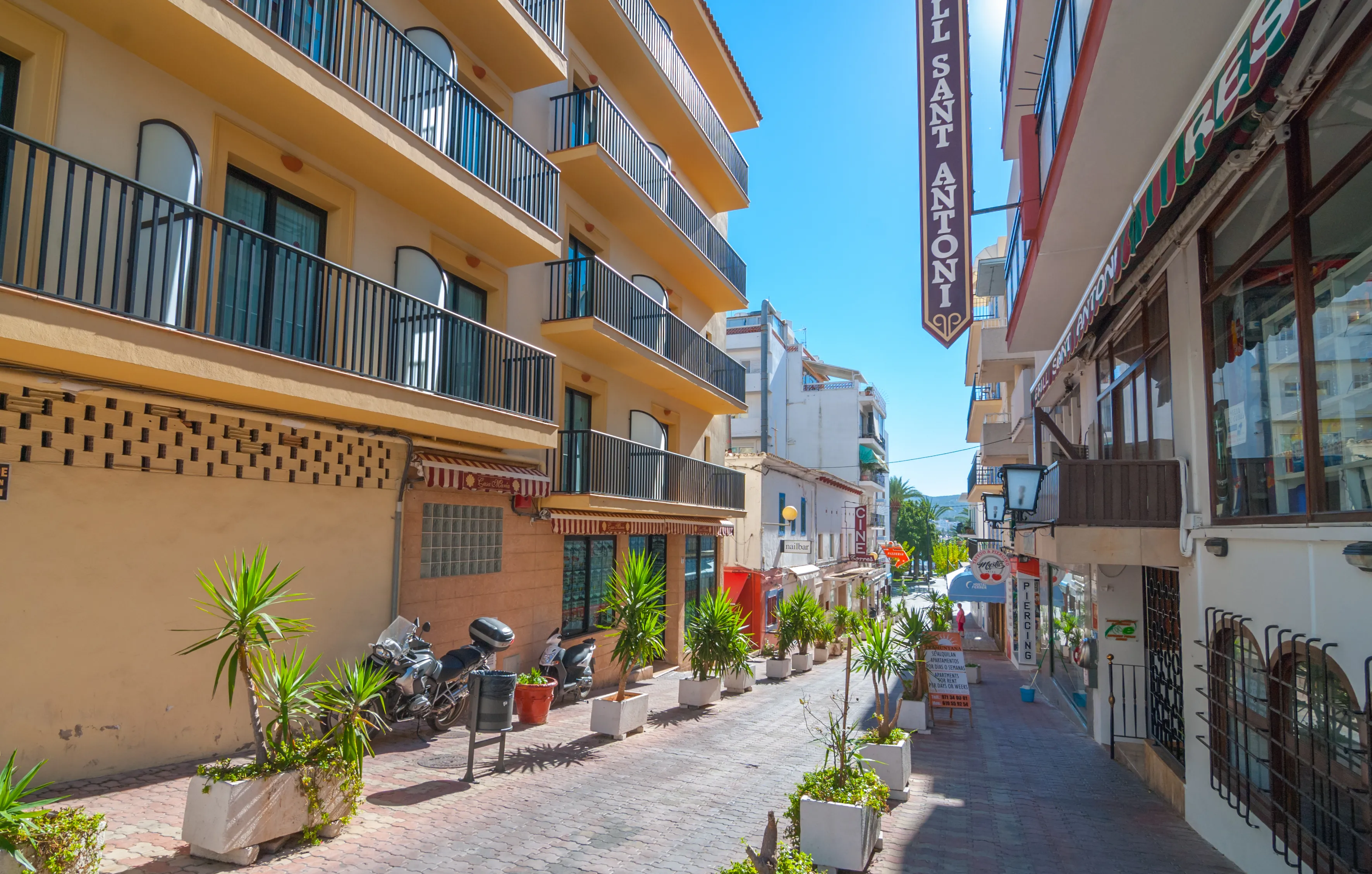 Sant Antoni De Portmany, Ibiza, November 6th, 2013:   Tourism in Spain.  Bright sunshine on in town of Ibiza in the off-season.  Empty & quite colorful street and shops. 