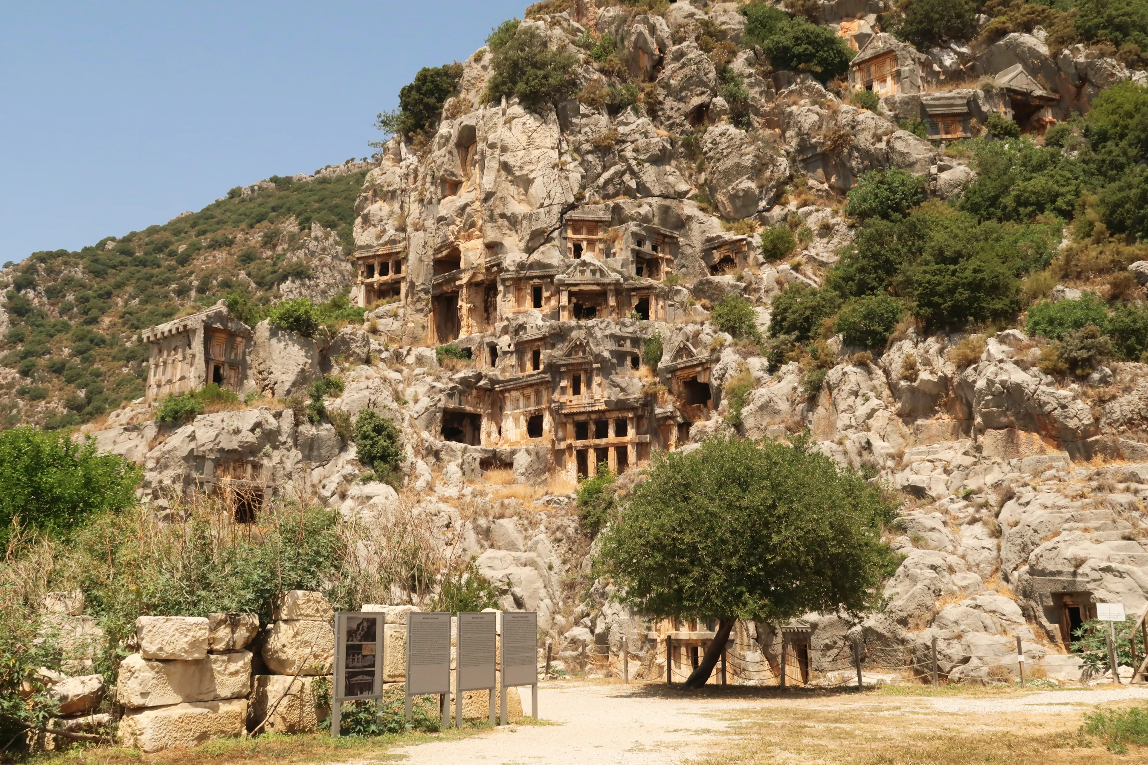 The archaeological site of Myra with its famous rock hewn, rock cut tombs on the cliff in the background, close to Demre, Turkey, 26th of May 2022