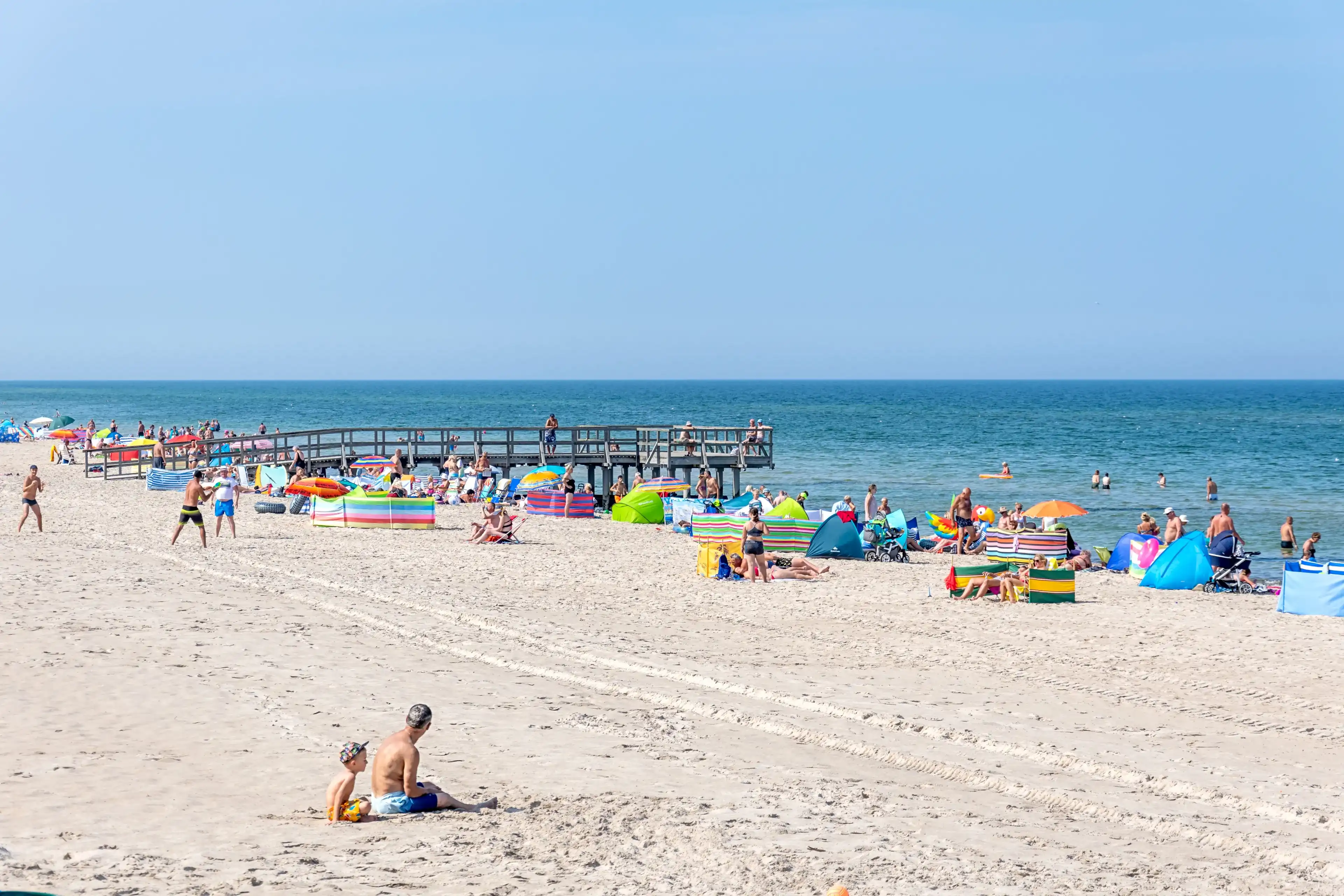 Mielno, Poland - September 29 2019: Baltic beach. Vacation by the sea. Few people are sunbathing on the sand. Holidays and fun on the water. Mielno, Poland - September 29 2019: Baltic beach. Vacation by the sea. Few people are sunbathing on the sand. Holidays and fun on the water.