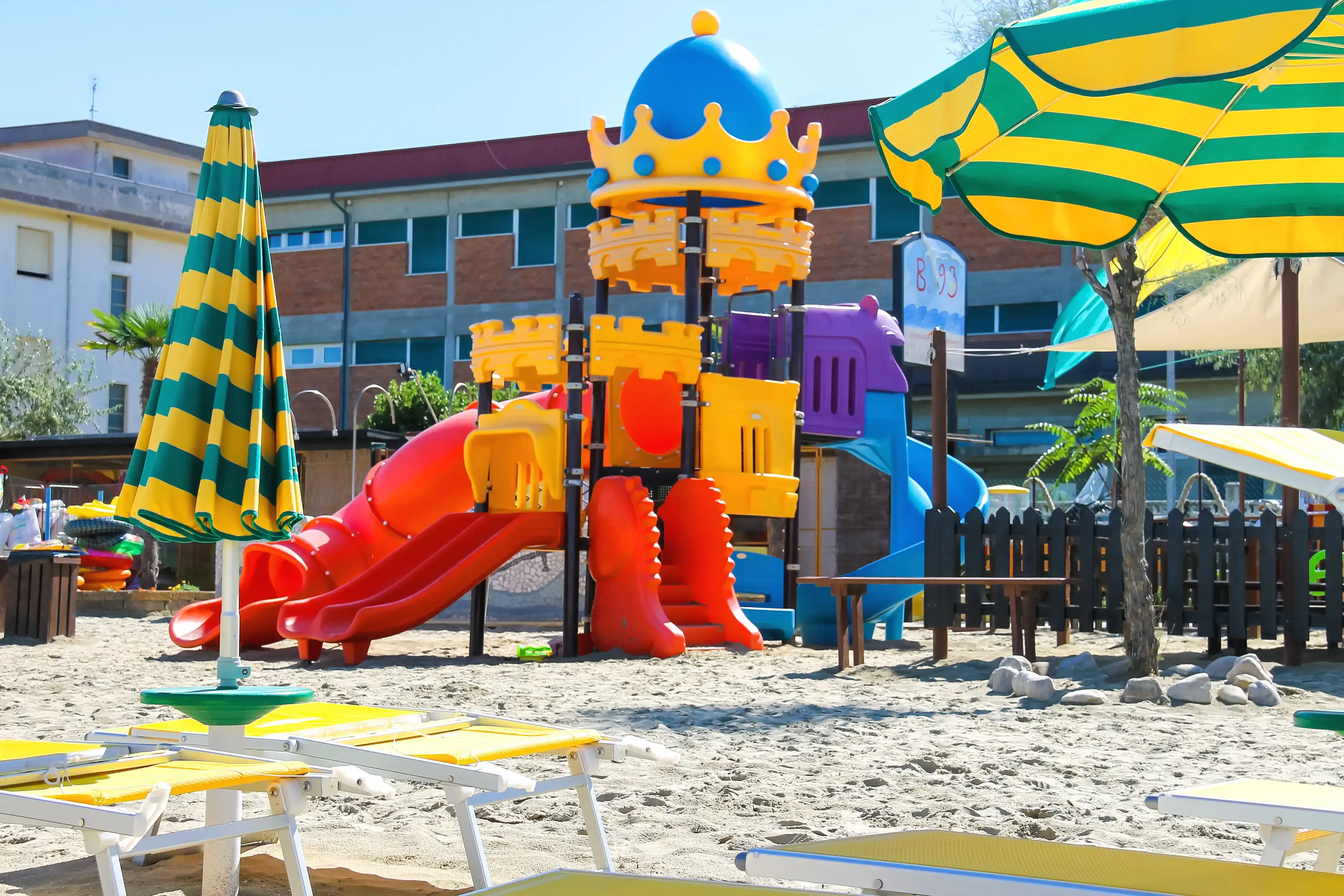 Children's playground, beach chairs and umbrellas on the beach in the resort town Bellaria Igea Marina, Rimini, Italy Children's playground, beach chairs and umbrellas on the beach in the resort town Bellaria Igea Marina, Rimini, Italy