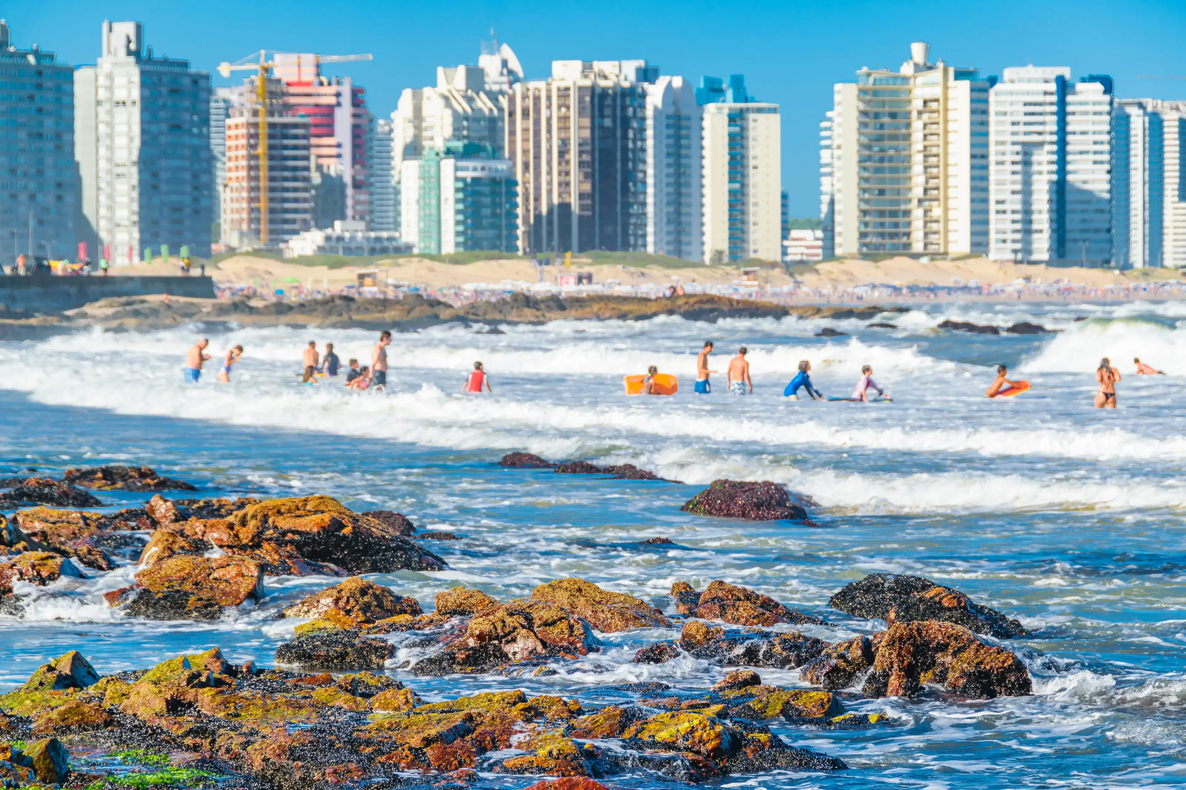 PUNTA DEL ESTE, URUGUAY, FEBRUARY - 2020 - People bathing at famous brava beach in punta del este city, Uruguay PUNTA DEL ESTE, URUGUAY, FEBRUARY - 2020 - People bathing at famous brava beach in punta del este city, Uruguay