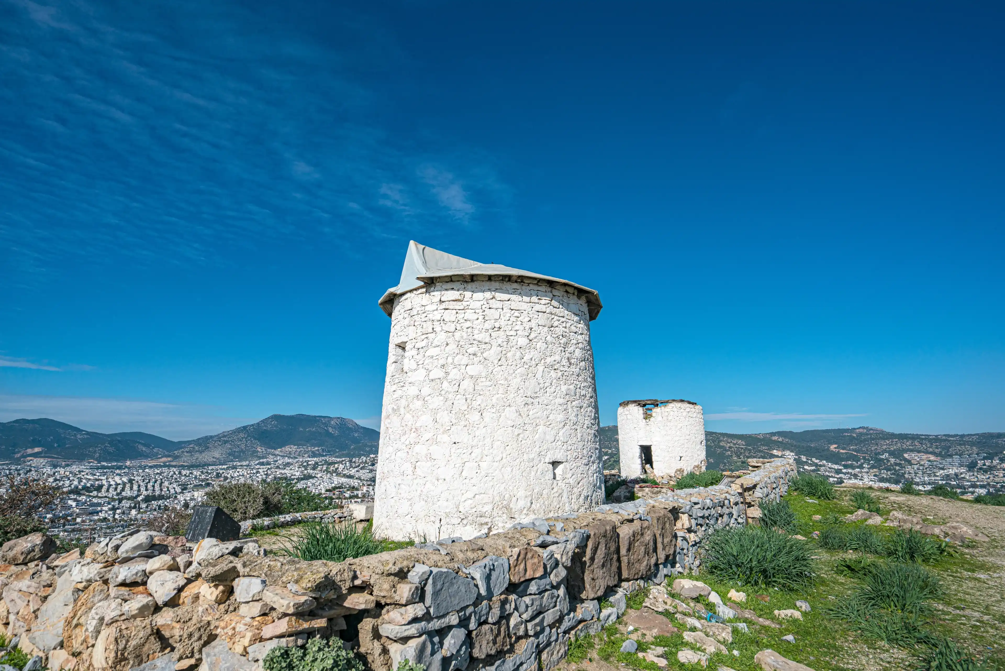 The windmills of Bodrum are a collection of stone buildings that were constructed in the 18th century and were used to grind grain into flour located on the hills between Bodrum and Gumbet, Yalikavak The windmills of Bodrum are a collection of stone buildings that were constructed in the 18th century and were used to grind grain into flour located on the hills between Bodrum and Gumbet, Yalikavak