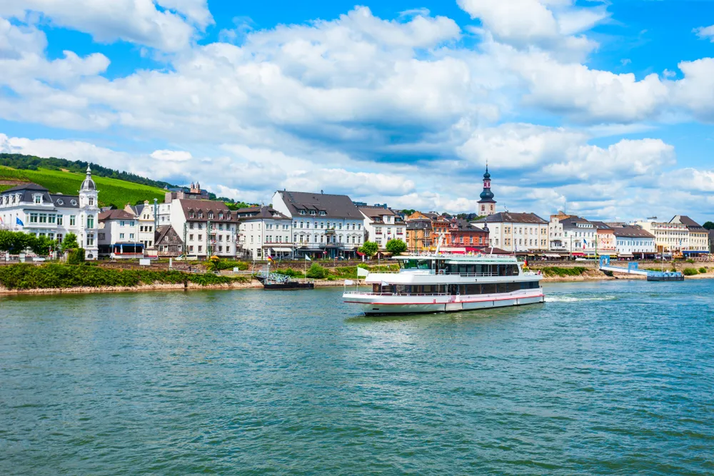 Tourist cruse boat near the Bingen am Rhein town at the Rhine valley in Germany