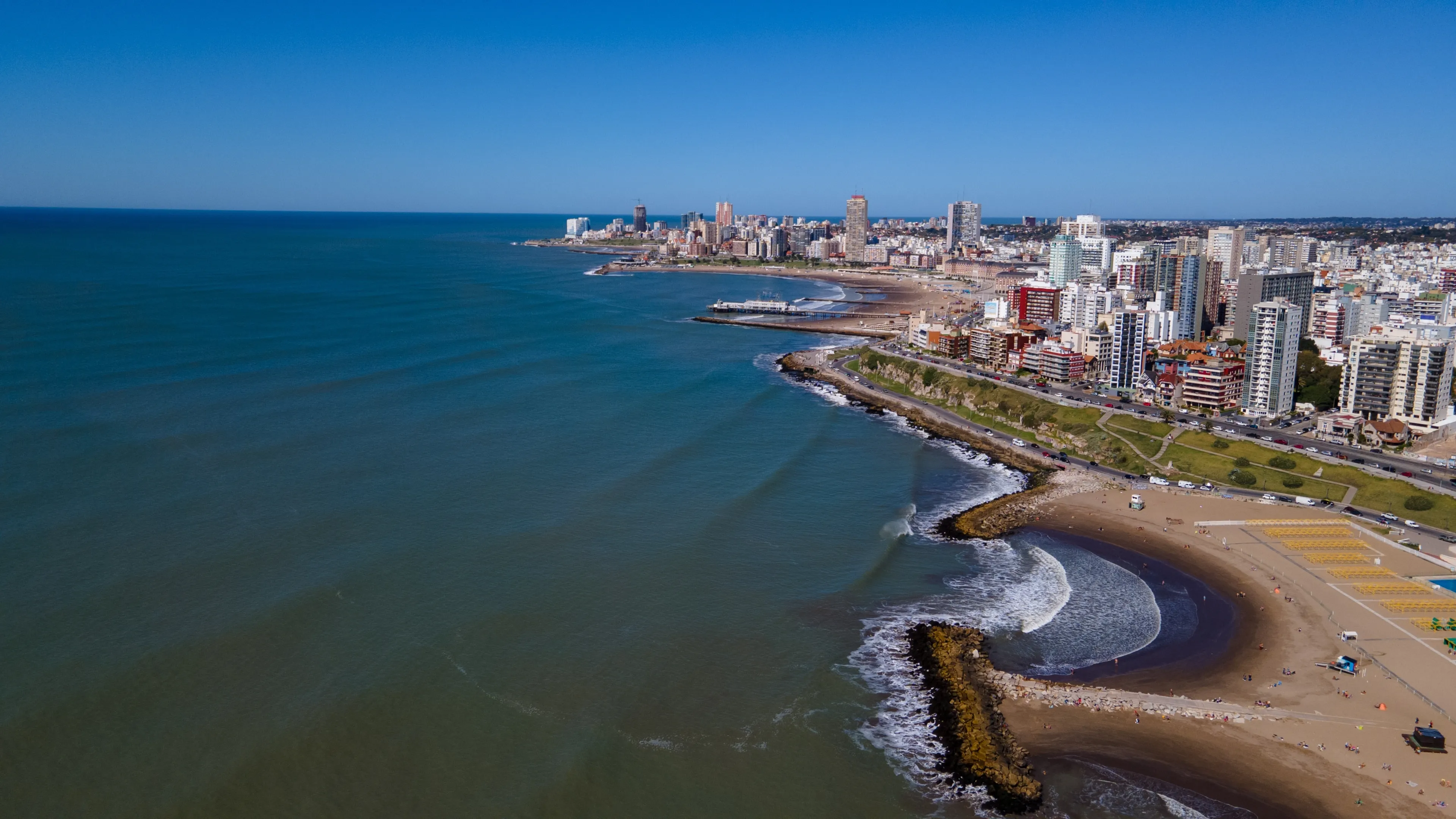 Aerial photo of the coast in beautiful morning with radiant sunshine. City of Mar del Plata captured with drone. 