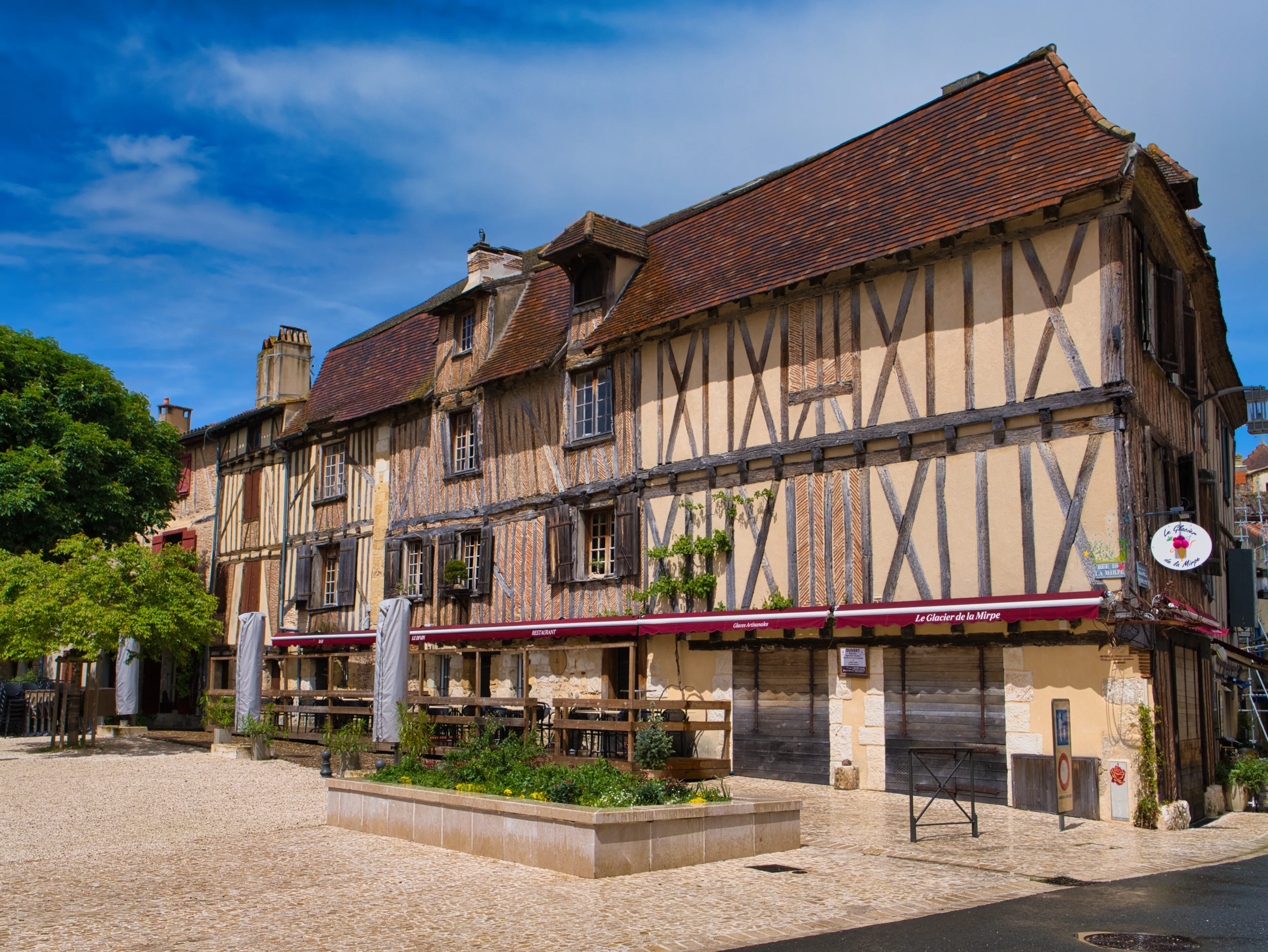 Bergerac, France - May 2 2024: The half-timbered building of the Glacier de la Mirpe in the Place de la Mirpe, Bergerac, in the Dordogne region of France. Taken on a sunny day with a blue sky.