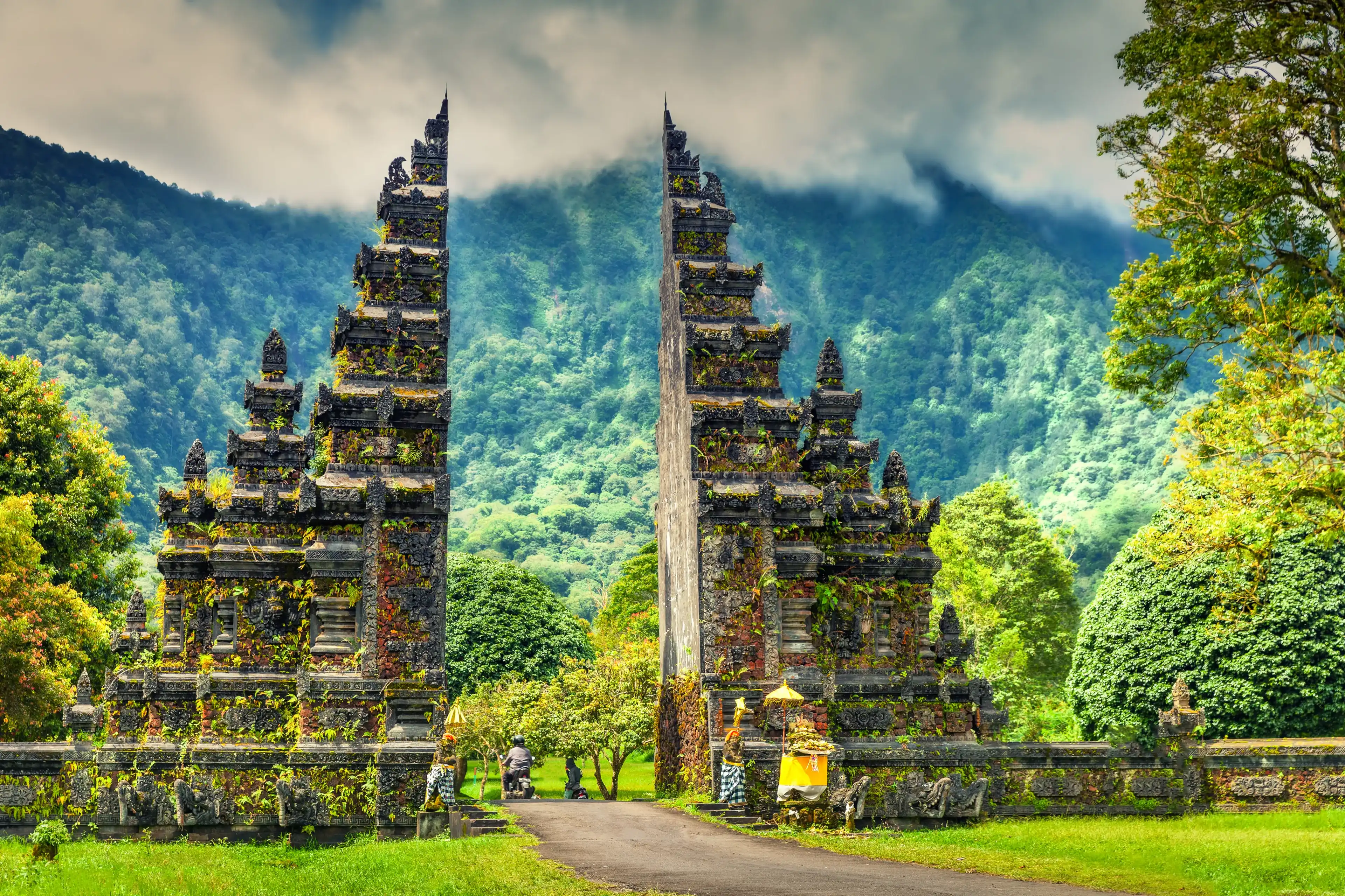 Traditional Hindu gate at rainy day - Candi Bentar, Bedugul in Bali, Indonesia. Entrance to the Hindu temple. Candi Bentar gate at rainy day. Bali gates. Indonesia Traditional Hindu gate at rainy day - Candi Bentar, Bedugul in Bali, Indonesia. Entrance to the Hindu temple. Candi Bentar gate at rainy day. Bali gates. Indonesia