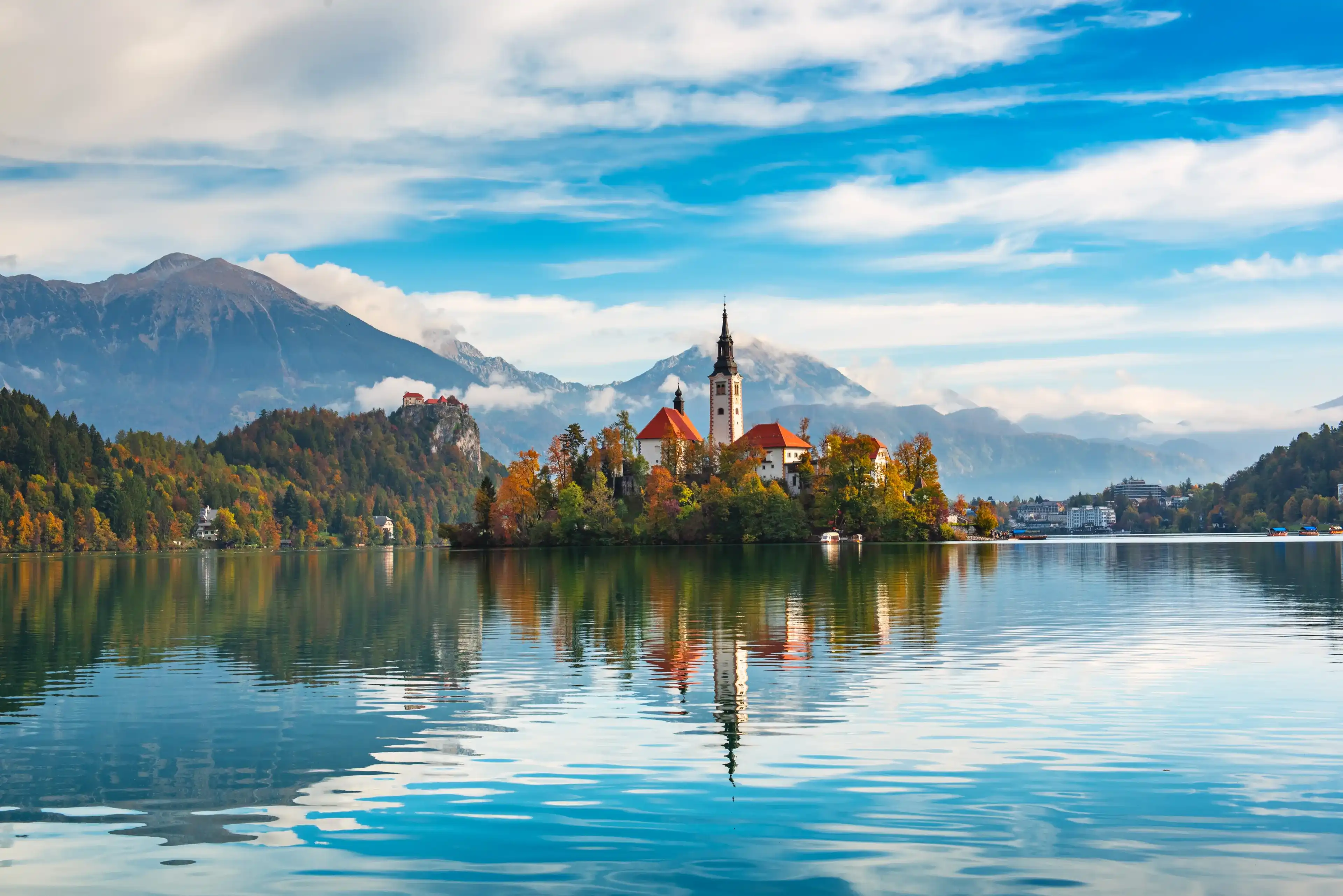 Church of Assumption in Lake Bled, Slovenia with blue sky and clouds in the autumn Church of Assumption in Lake Bled, Slovenia with blue sky and clouds in the autumn