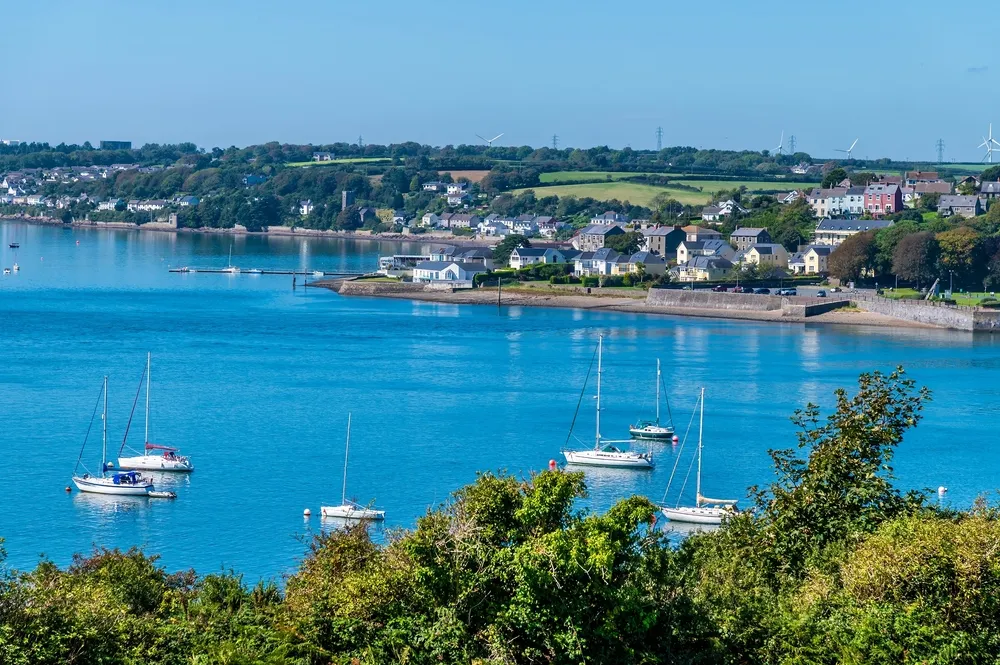 A view past boats moored in the river estuary at Pembroke Dock, Wales in summertime