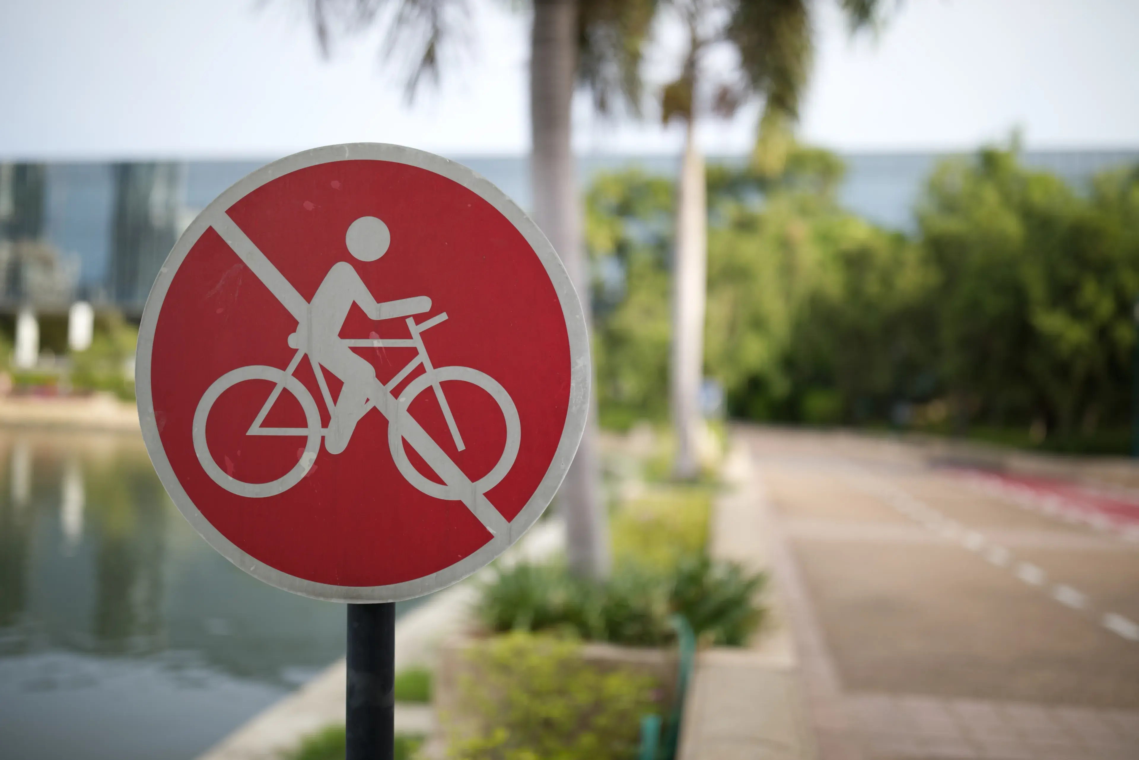 do not use bicycle or don't ride the bike in this lane sign red and white color road blur background do not use bicycle or don't ride the bike in this lane sign red and white color road blur background