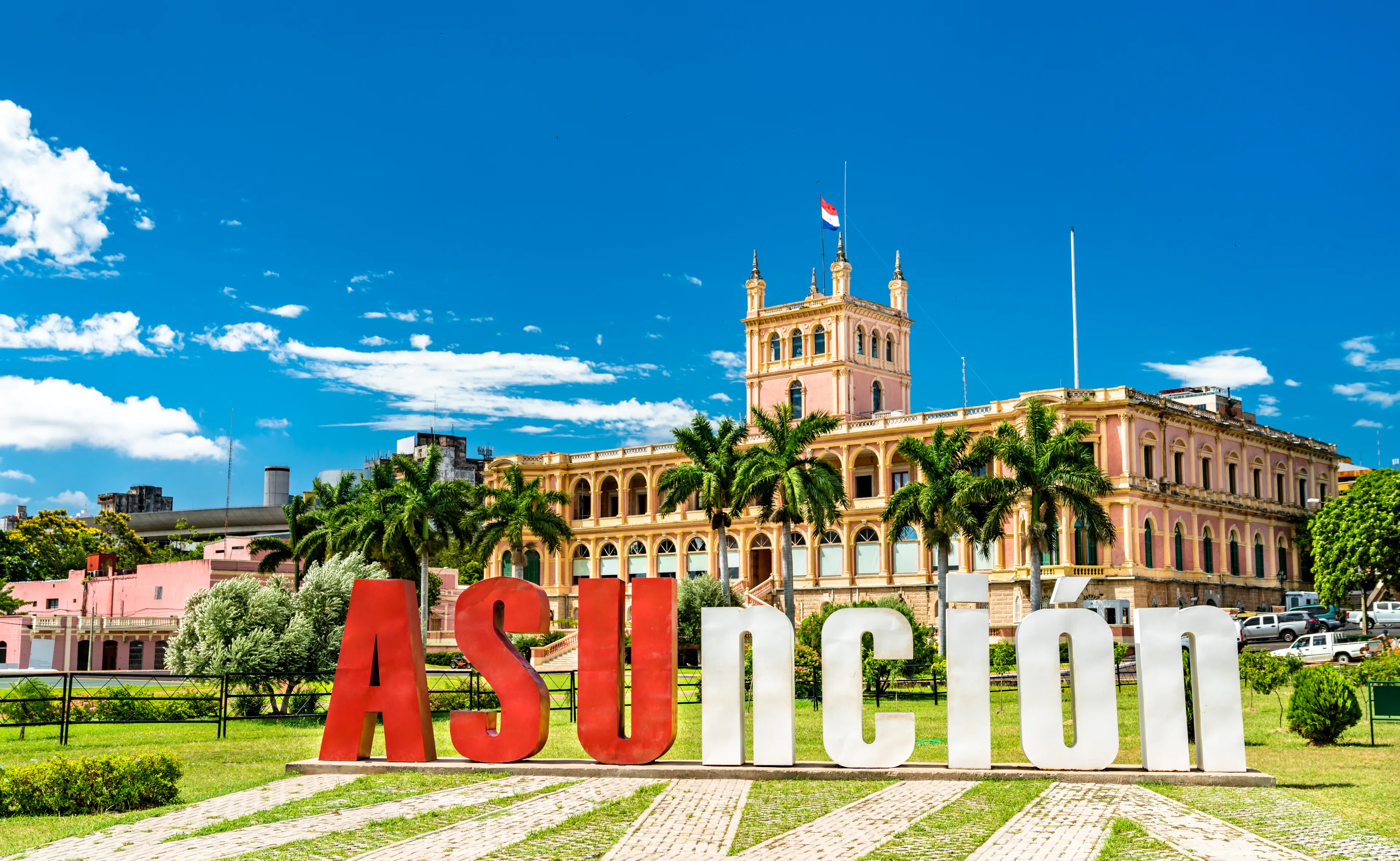 The welcome sign and Palace of the Lopez in Asuncion, Paraguay