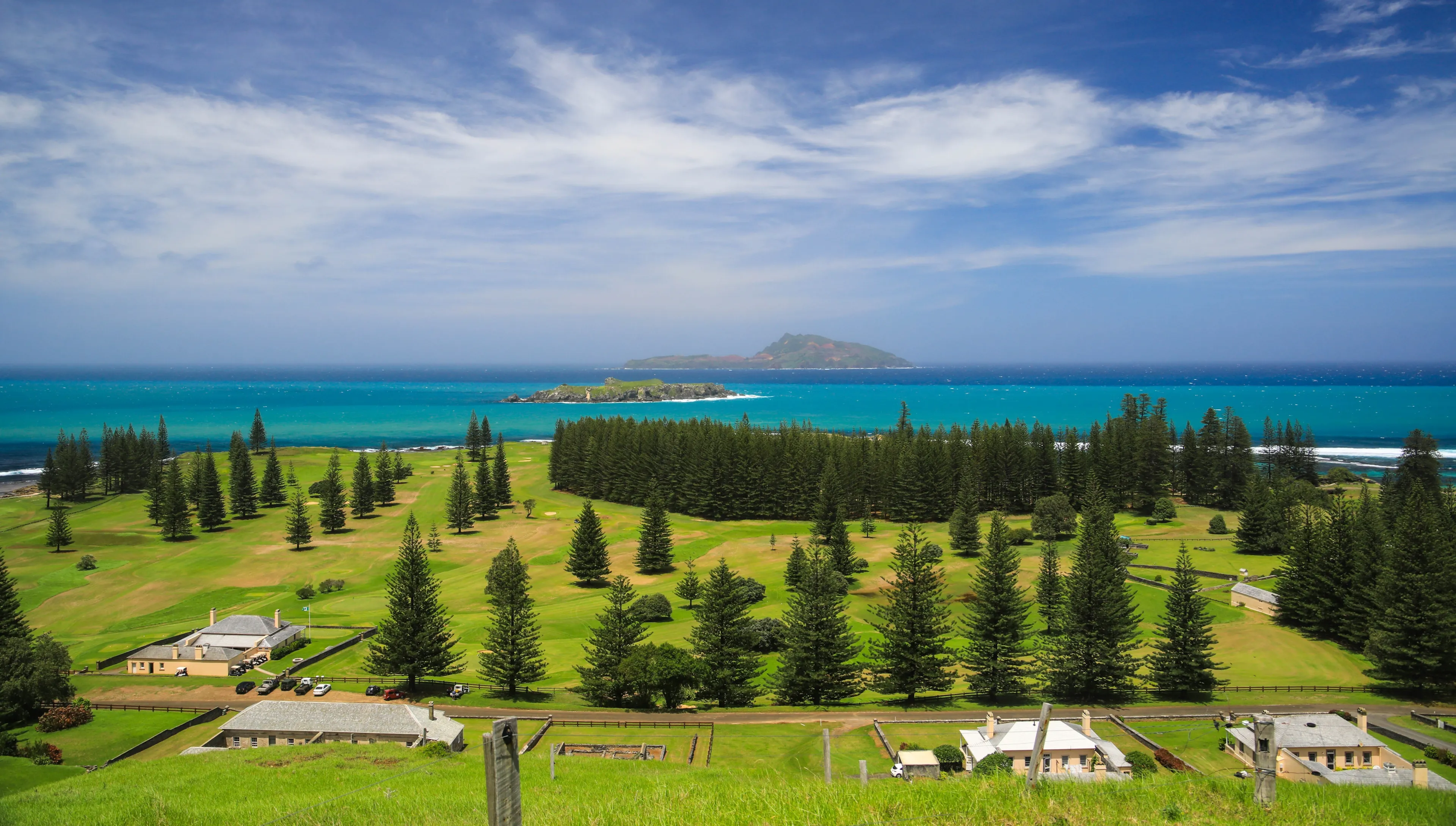 View from Queen Elizabeth lookout across green Norfolk Island and blue waters towards Phillip and Nepean Islands