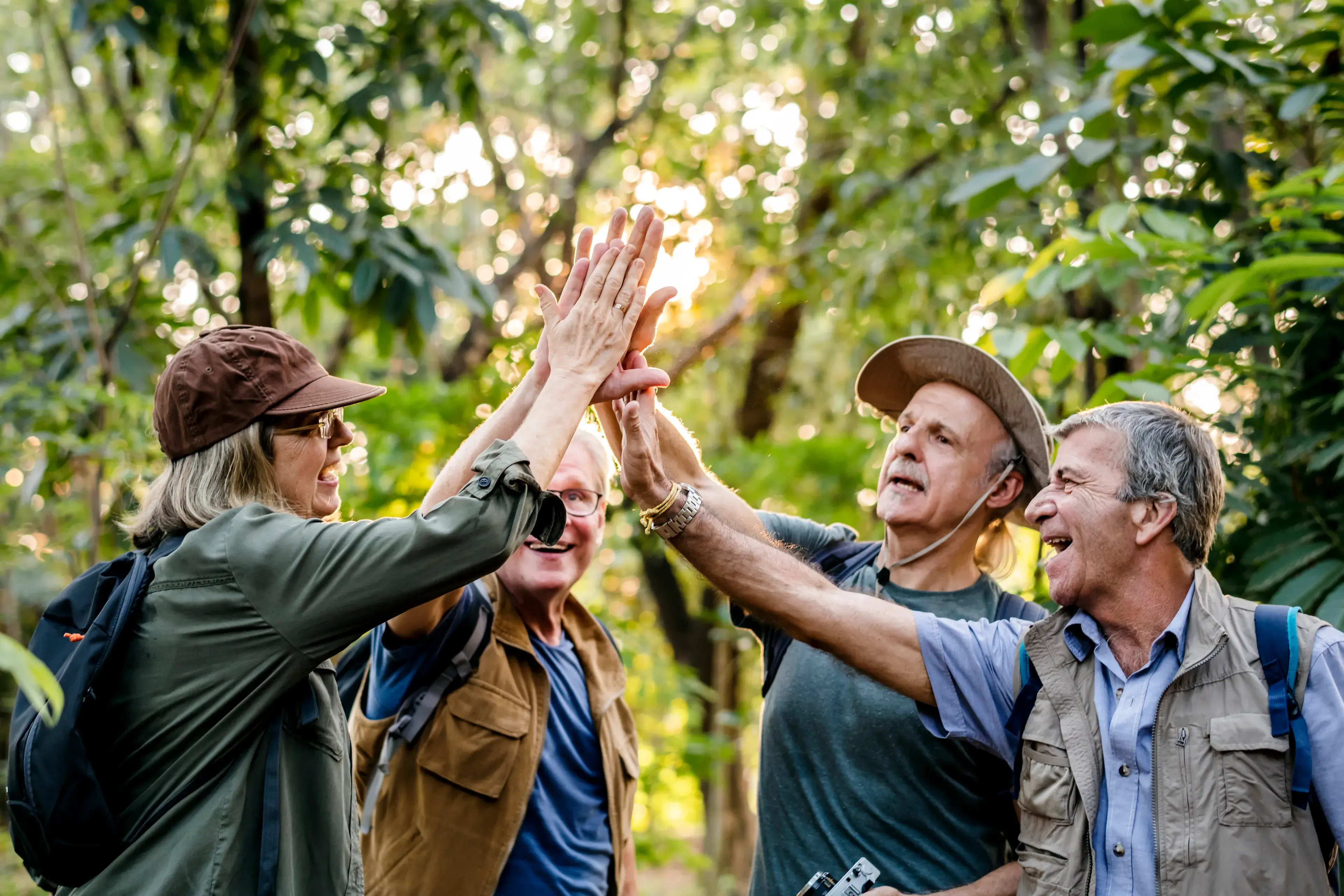 Senior trekkers giving a high five Senior trekkers giving a high five