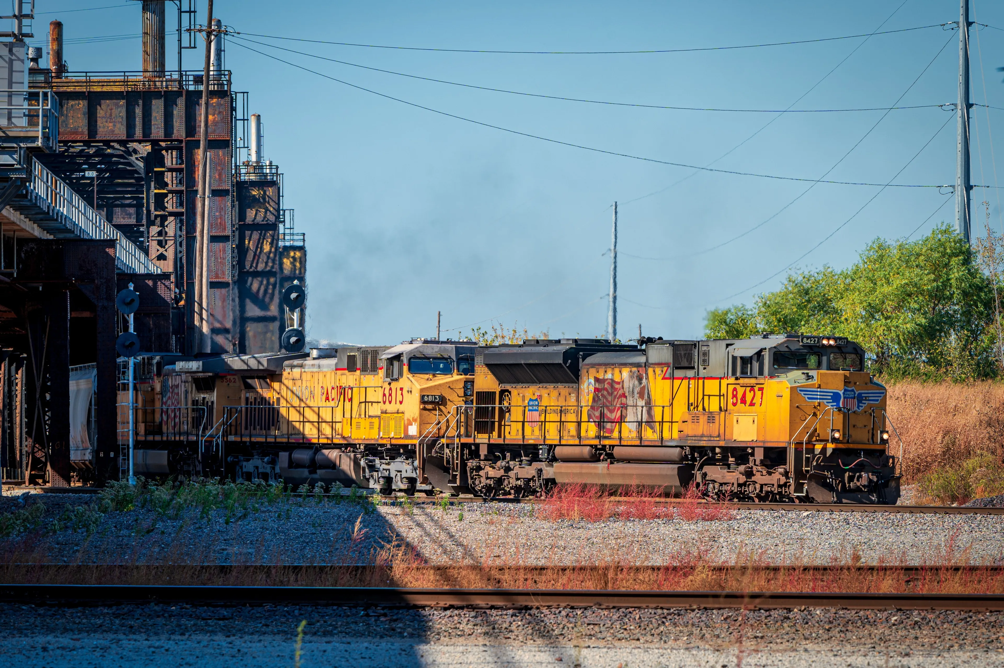 KANSAS CITY, US - Oct 22, 2022: The Union Pacific locomotive exiting lower bridge with plumes of black smoke