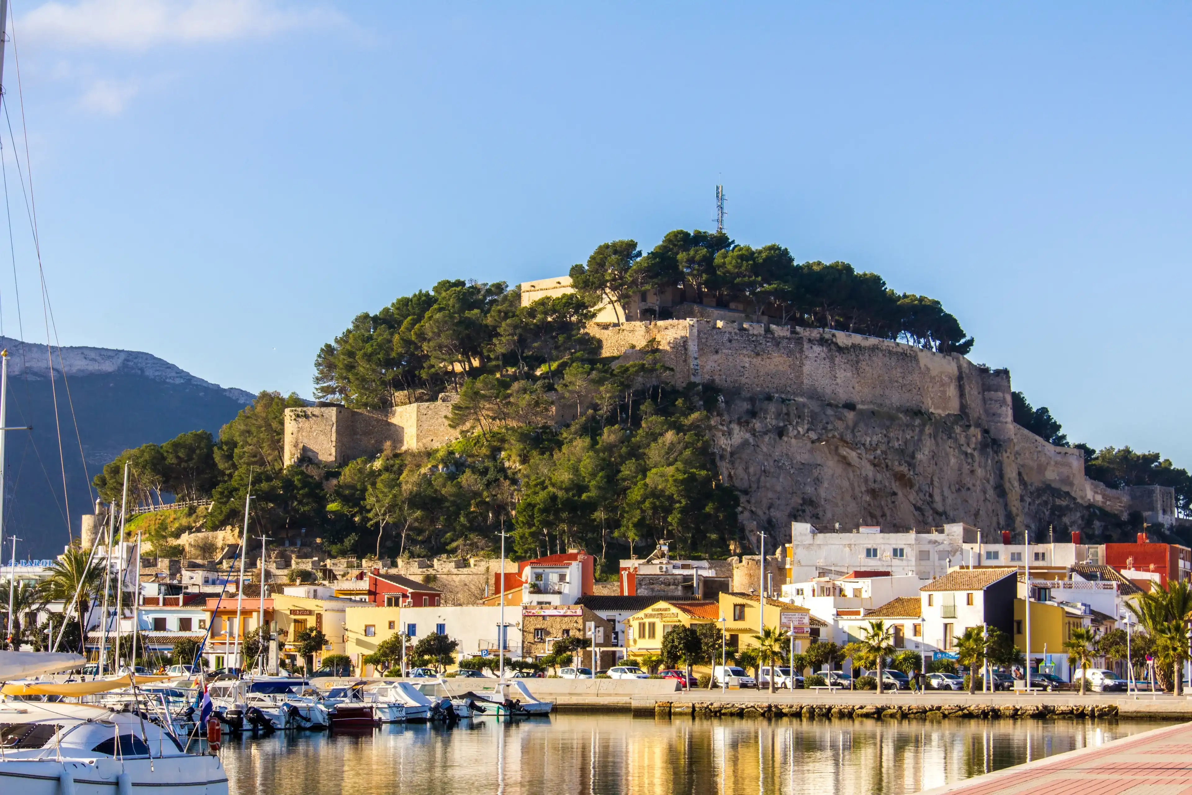 Denia, Spain - February 12, 2019: Panoramic view of Denia Port Marina promenade and Castle Denia, Spain - February 12, 2019: Panoramic view of Denia Port Marina promenade and Castle