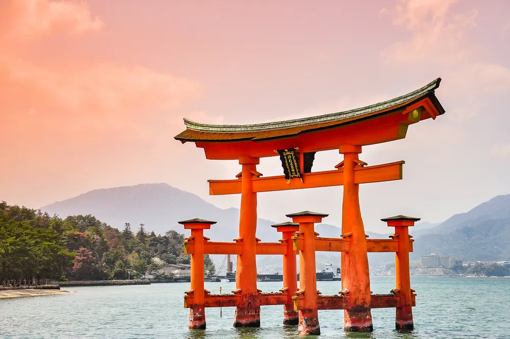 Miyajima, Hiroshima, Japan at the floating gate of Itsukushima Shrine. (gate sign reads Itsukushima Shrine)