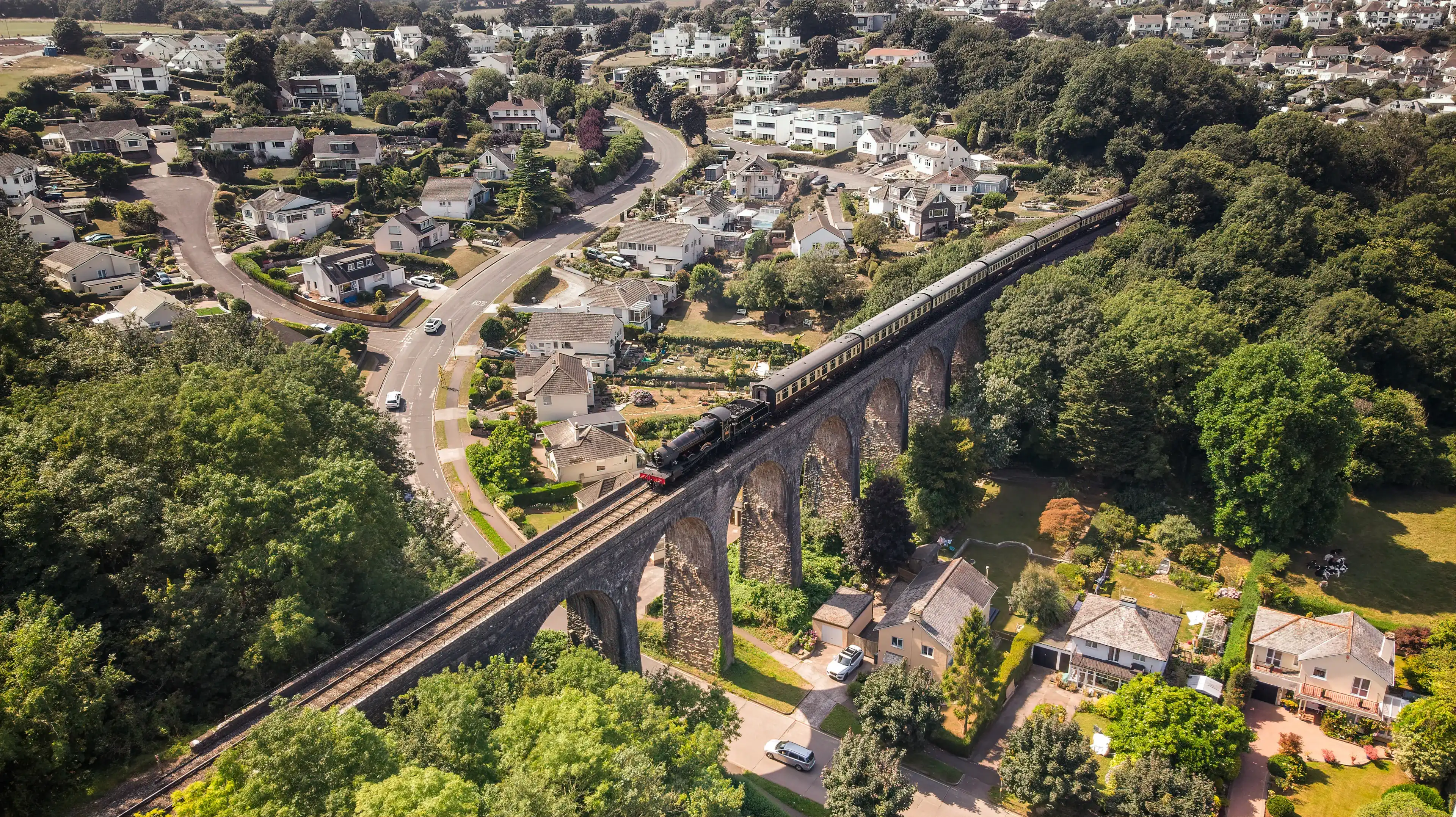 Aerial drone view of the Dartmouth Steam railway locomotive passing over the broadsands viaduct Aerial drone view of the Dartmouth Steam railway locomotive passing over the broadsands viaduct