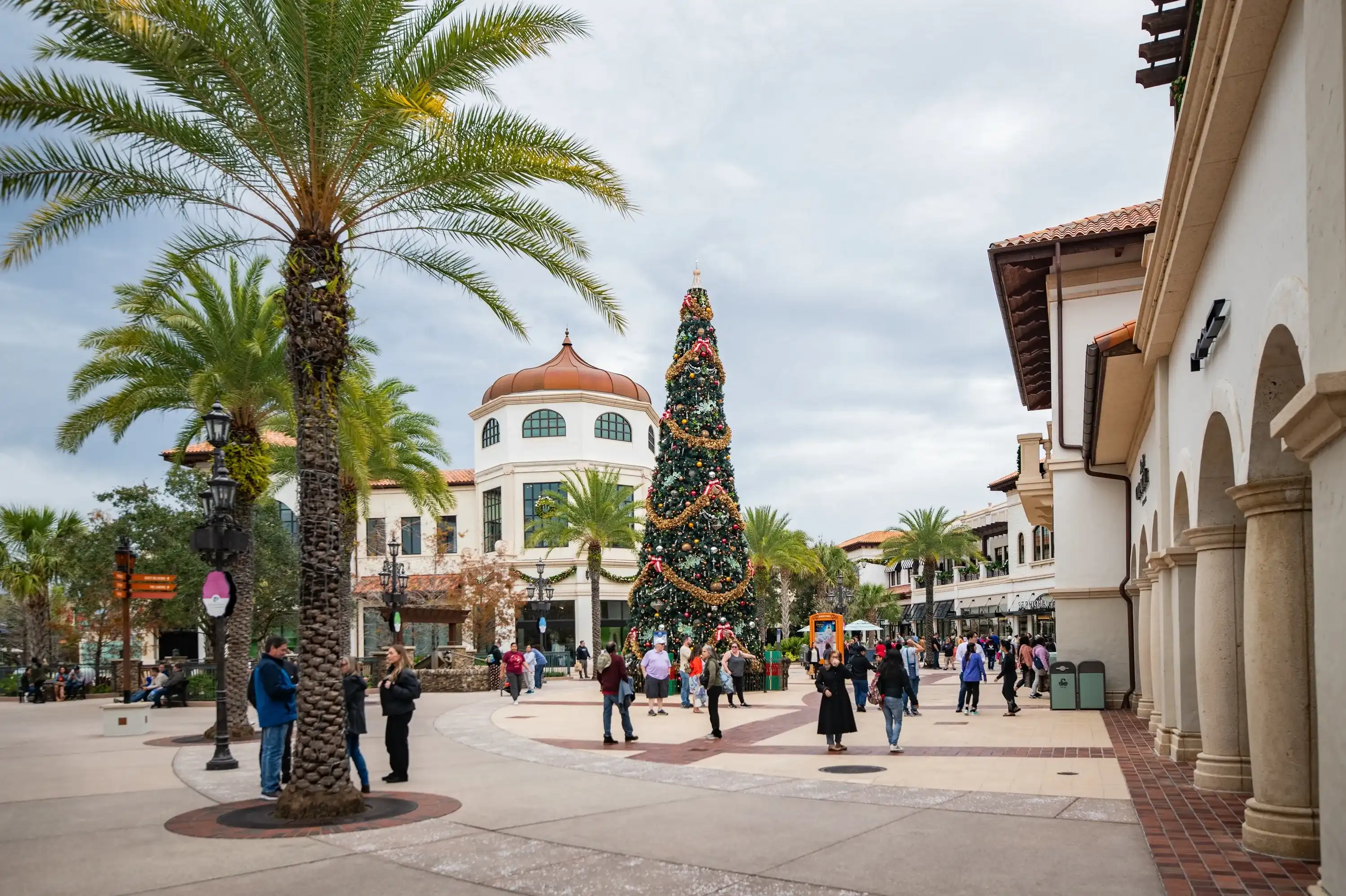 Lake Buena Vista, FL, USA- Jan 8, 2024: Palm tree pedestrian walkway at Disney Springs in Lake Buena Vista, Orlando, Florida decorated for christmas nara the Zara store Lake Buena Vista, FL, USA- Jan 8, 2024: Palm tree pedestrian walkway at Disney Springs in Lake Buena Vista, Orlando, Florida decorated for christmas nara the Zara store