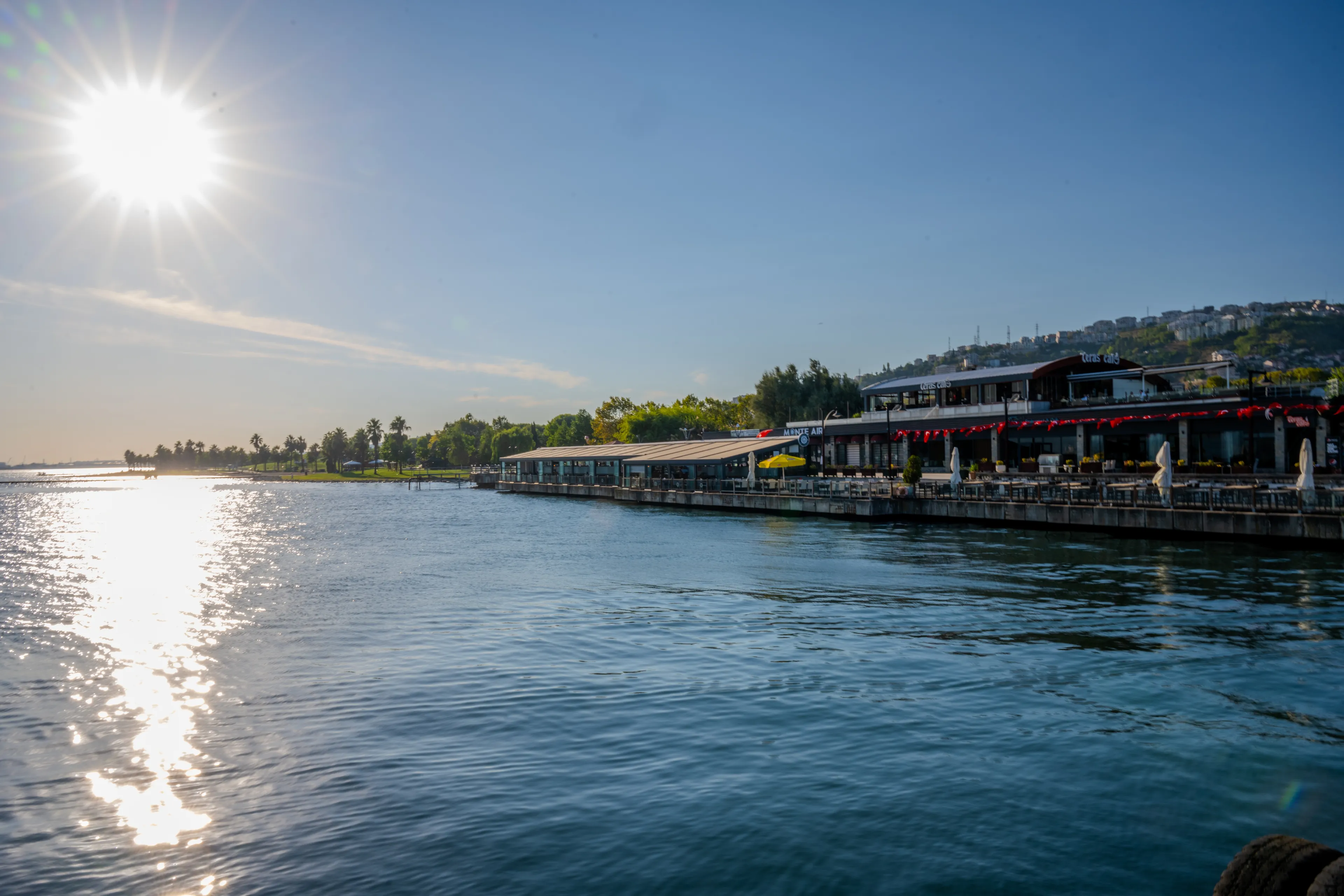 Sunlit Waterfront Cafes and Promenade Along the Shores of Sapanca Lake in Kartepe, Sakarya, Türkiye - August 29, 2023